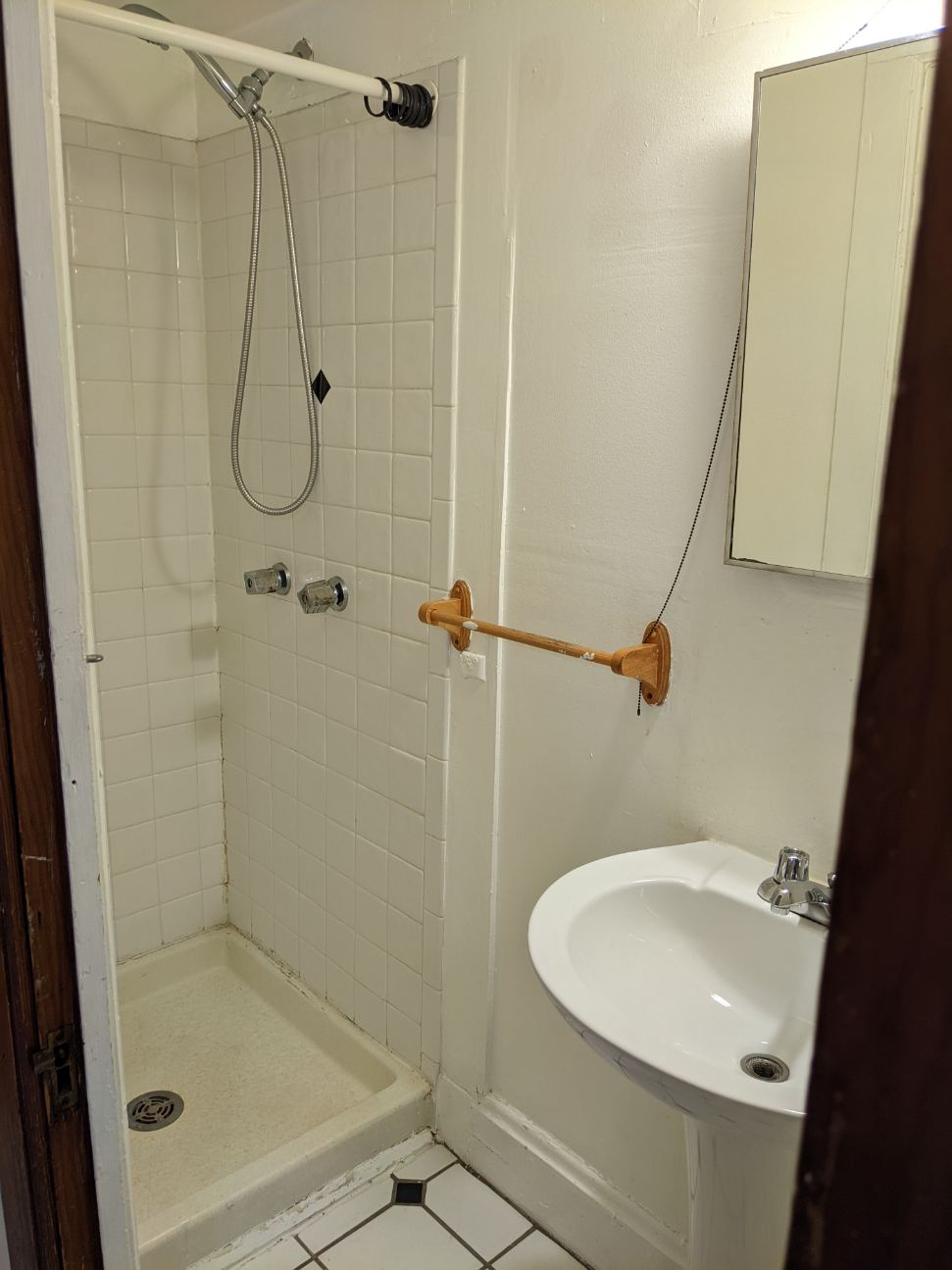 374 C E 14th Ave. bathroom with tiled stand-up shower and pedestal sink