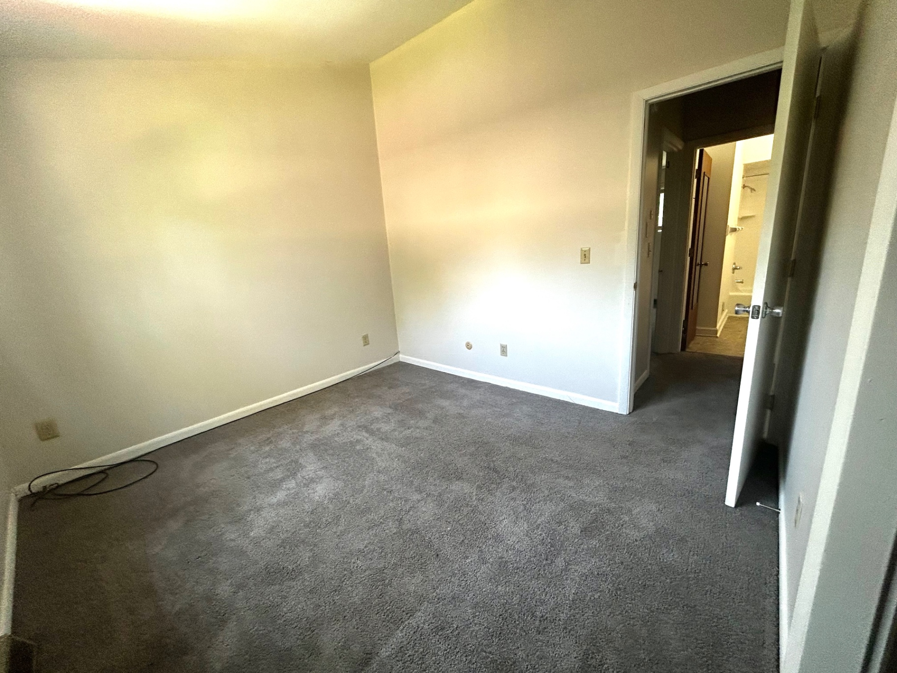 2011 Summit St. Unit E first bedroom with open doorway toward the hall