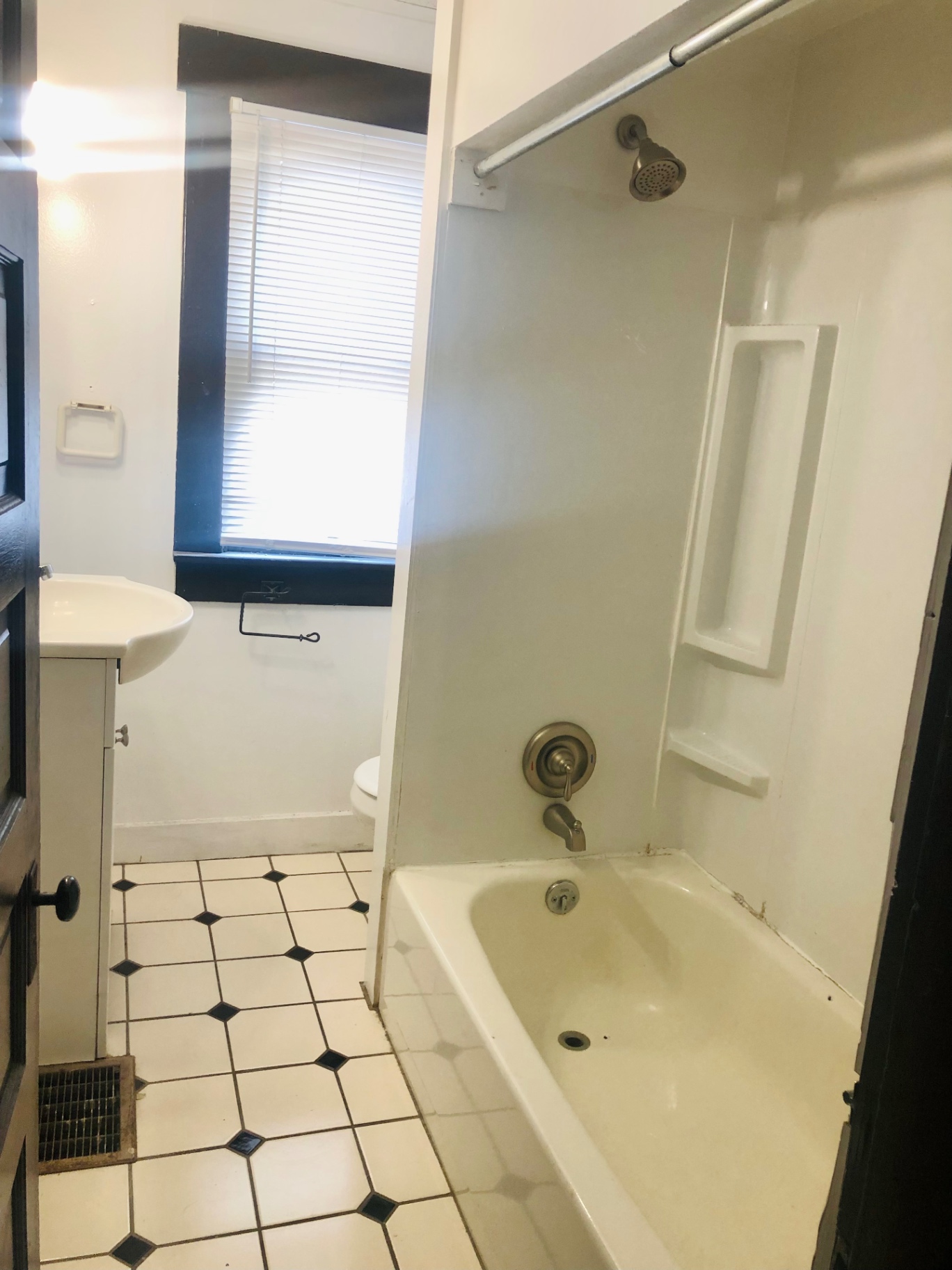 91½ E Woodruff Ave. bathroom with tub and shower surround, tile flooring, and natural light