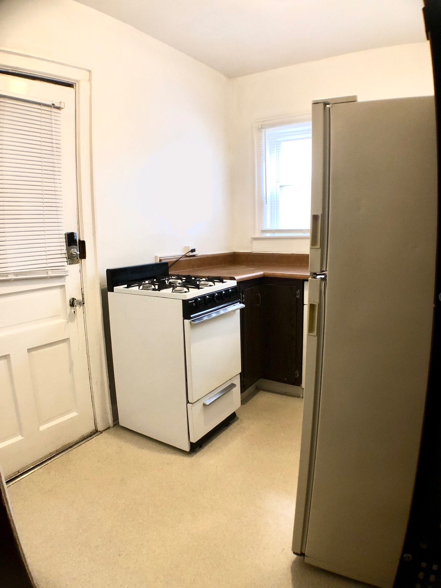2054 Iuka Ave. D kitchen with gas range, full-size refrigerator, and rear entry door