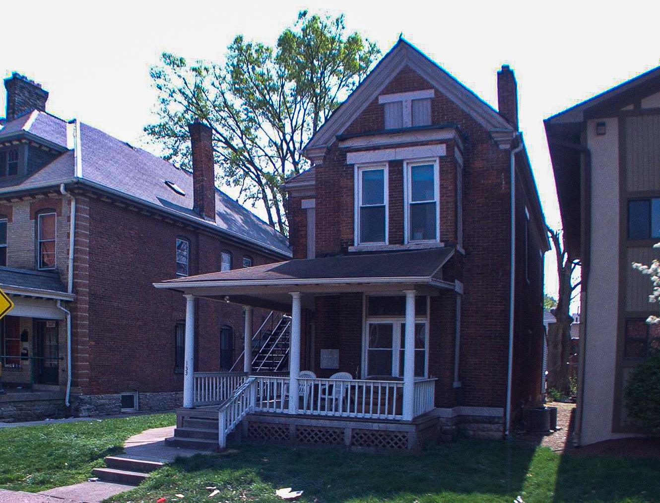 133 W 10th Ave. exterior — brick Victorian with covered front porch