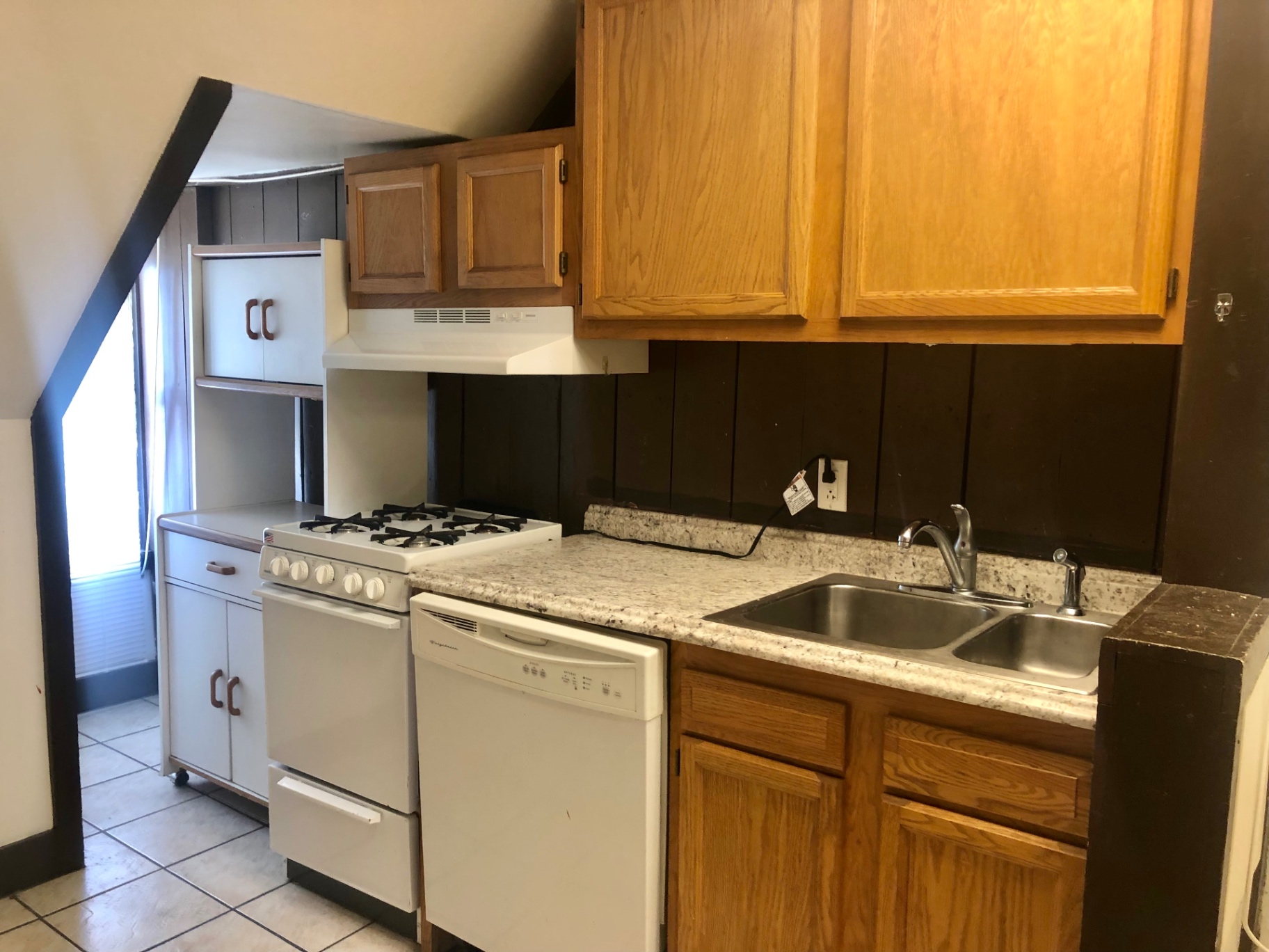 91½ E Woodruff Ave. kitchen with granite-look counters, gas range, dishwasher, and stainless double sink