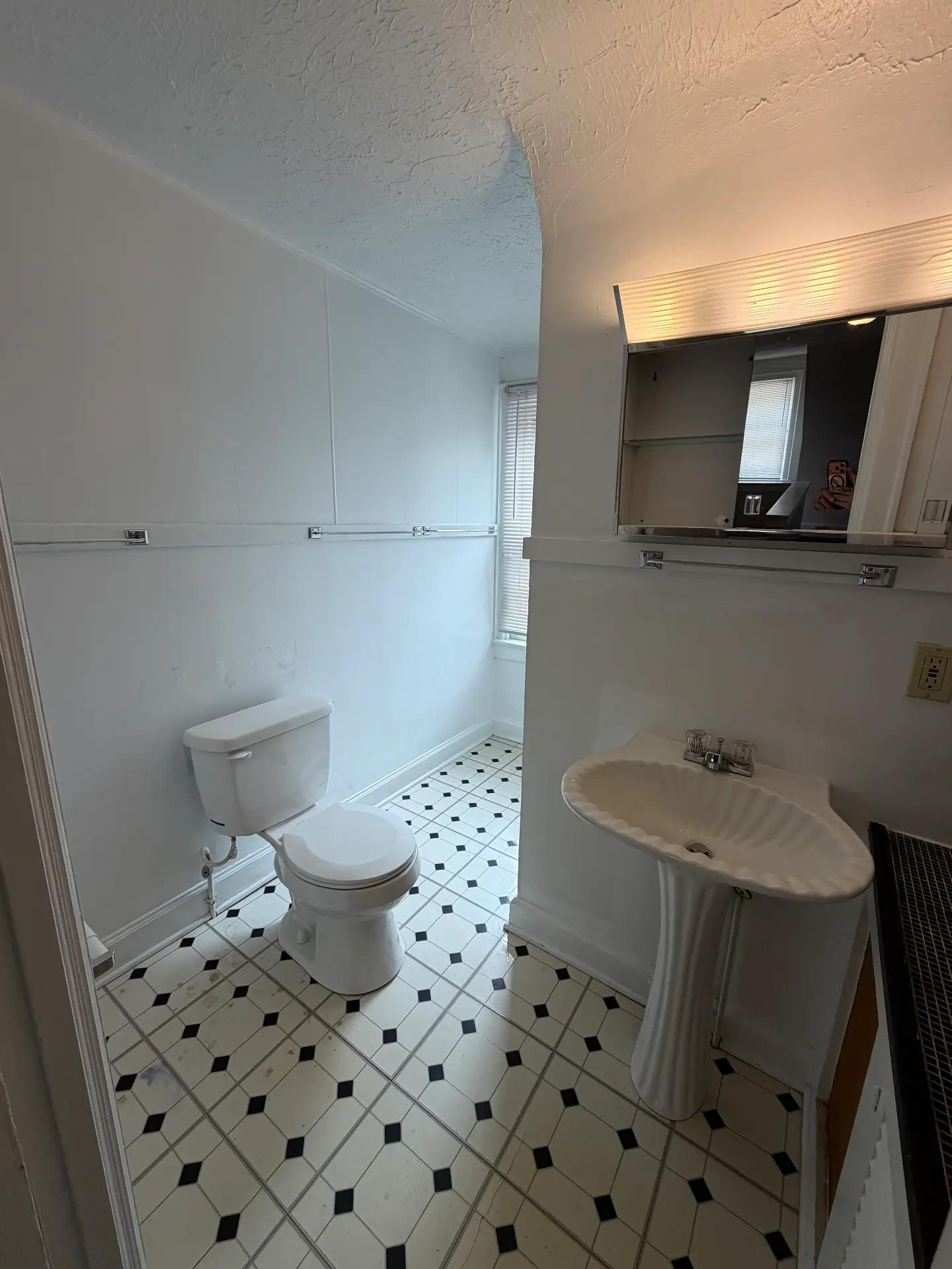 2048 Iuka Ave. D bathroom with pedestal sink, mirrored medicine cabinet, and black-and-white tile floor