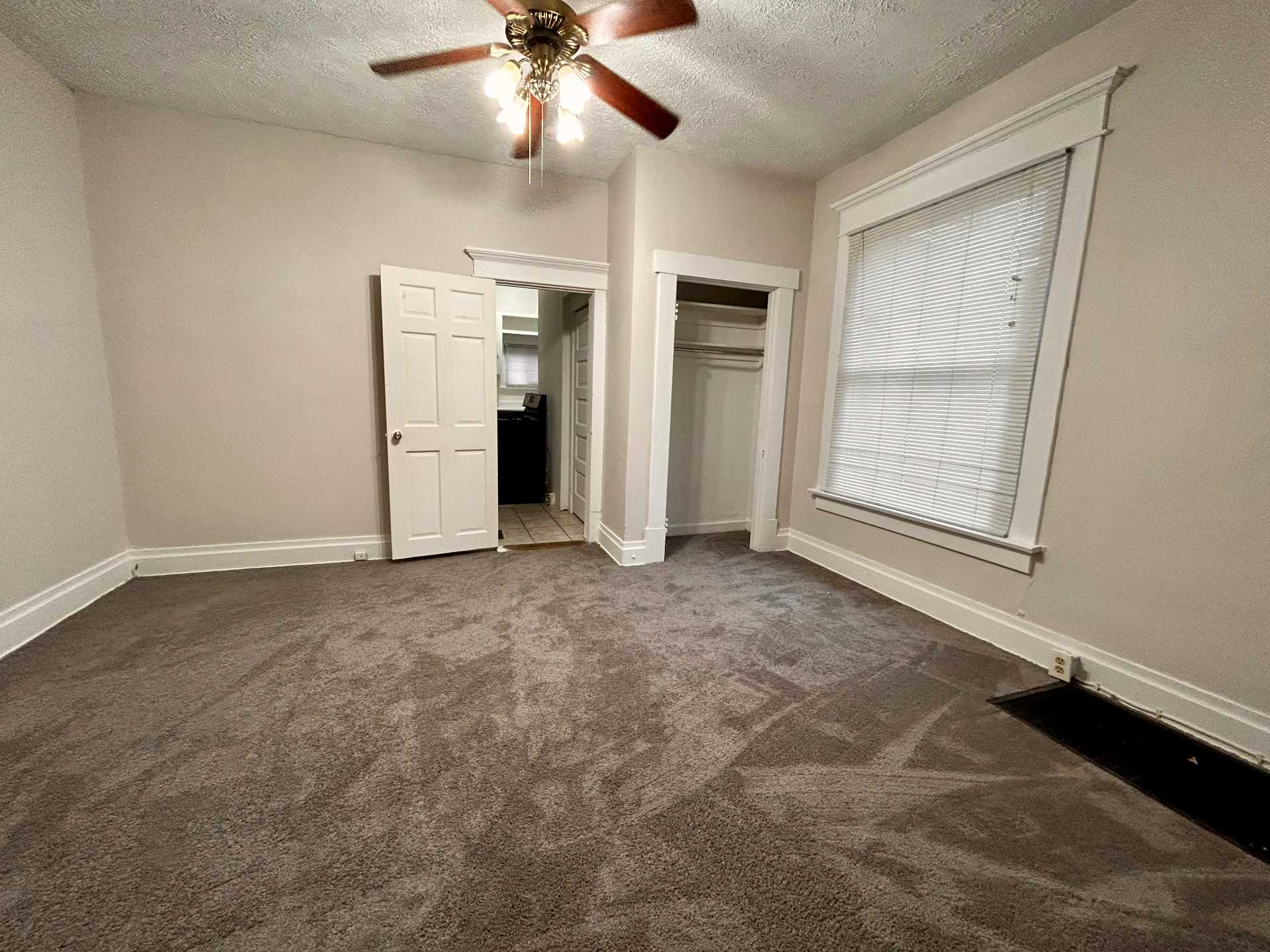 68 E Patterson Ave. carpeted bedroom with ceiling fan, reach-in closet, and large window