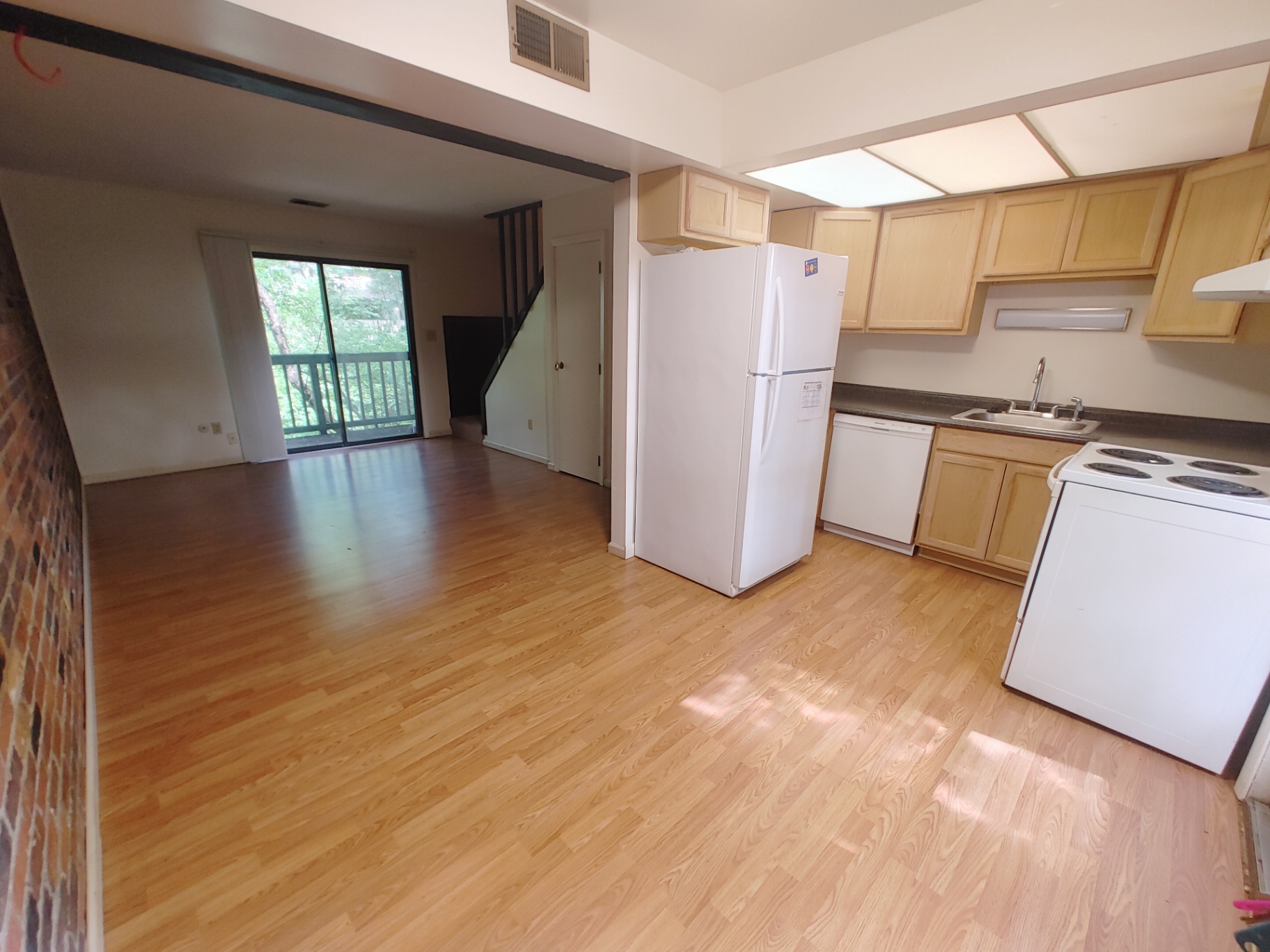 2020 Iuka Ave. bright open kitchen and living space with wood-look floors and exposed brick