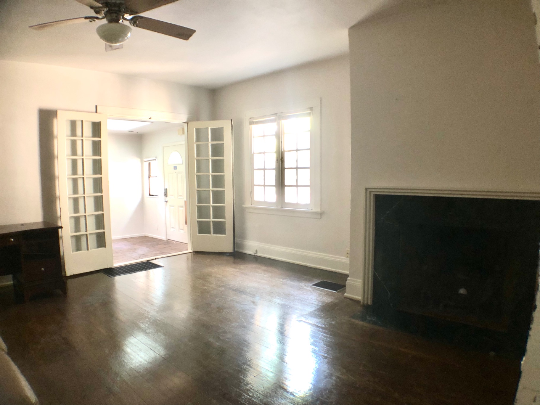 2026 Iuka Ave A wide living room view with French doors, fireplace, and glossy hardwood floors