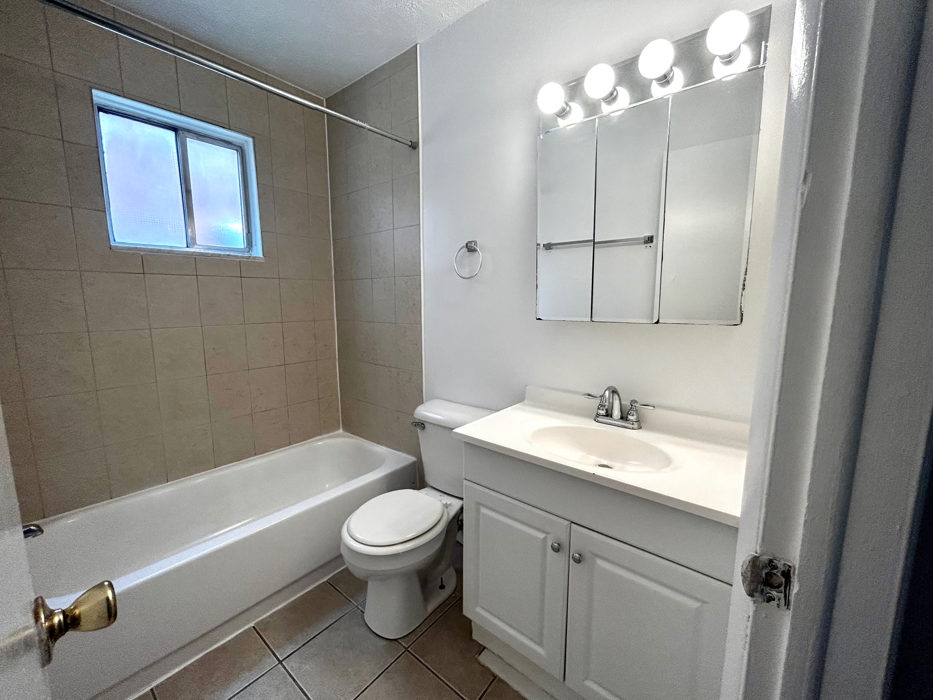2150 N 4th St. Unit C bathroom vanity and tub view with bright lighting and tile floors