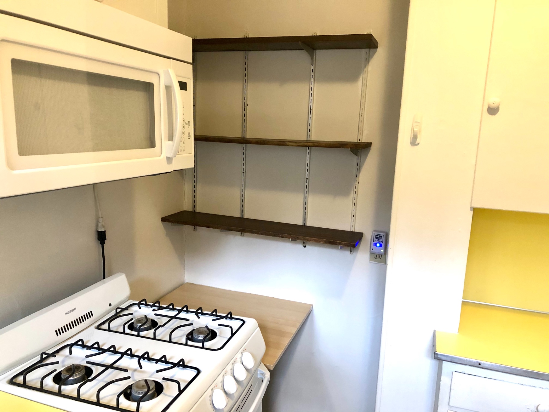 2044 Iuka Ave. B kitchen with open wood shelving and gas cooktop