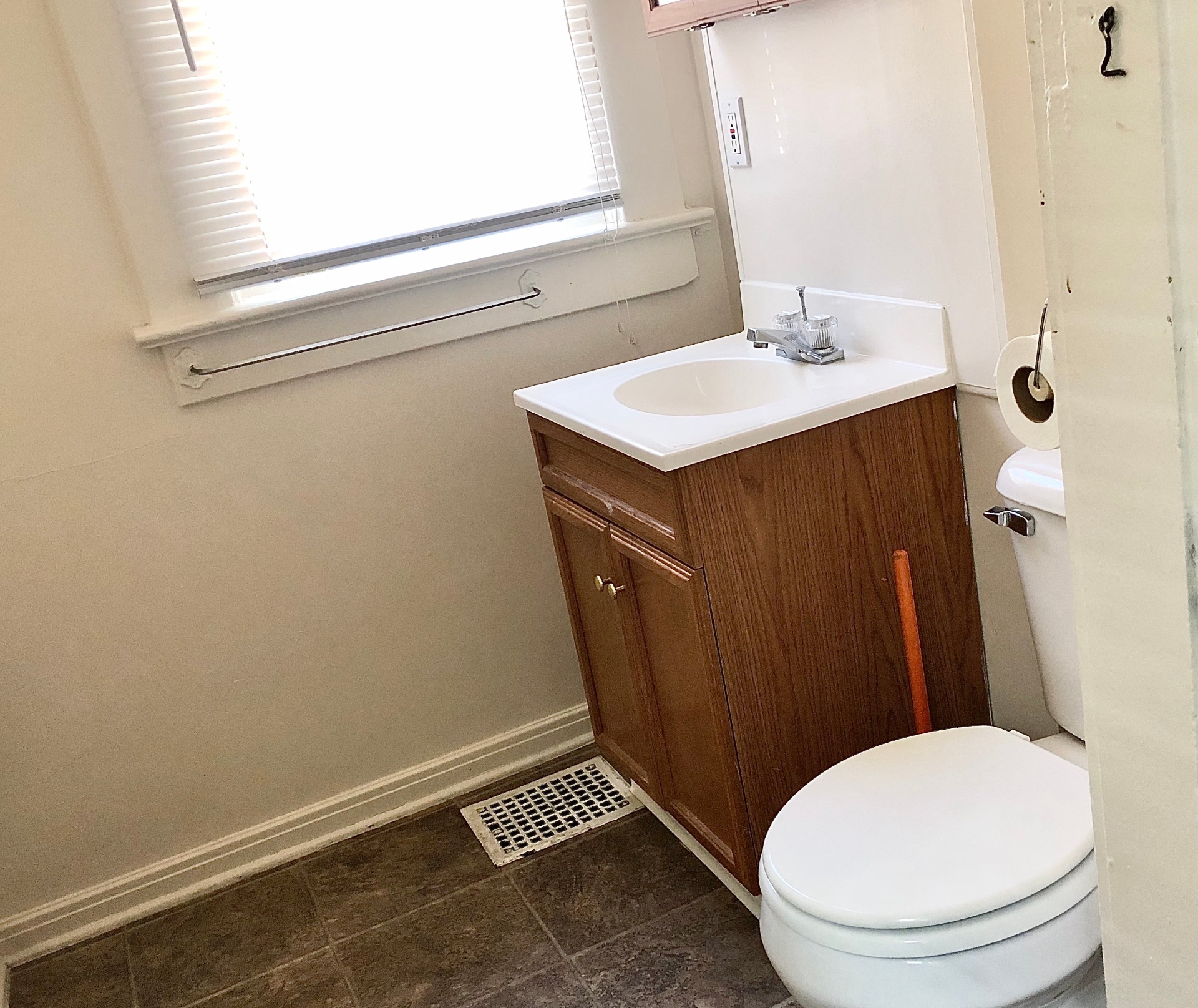 2015 Summit St. bathroom with oak vanity, tile floor, and bright window