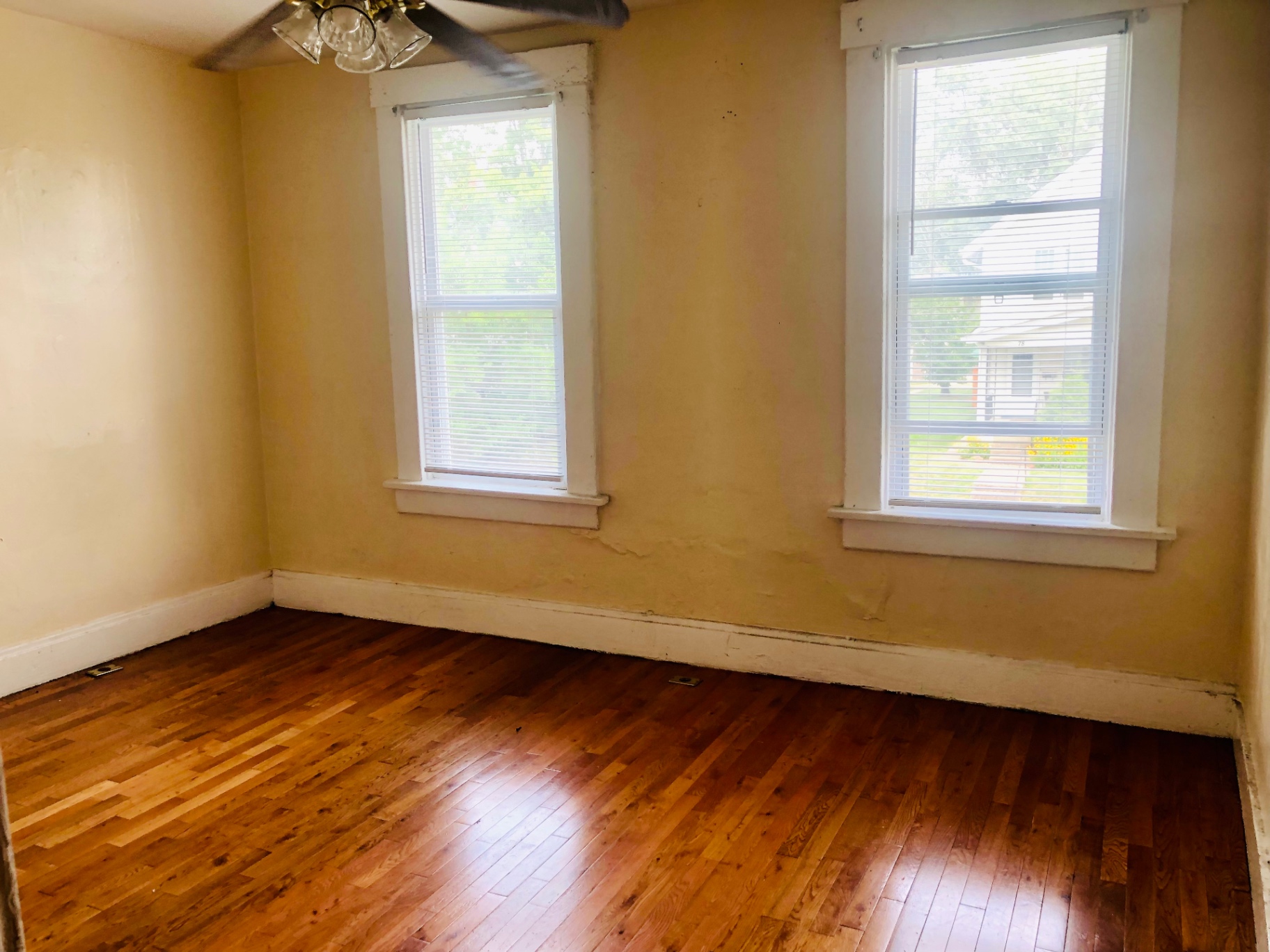 77 E Patterson Ave. bedroom with refinished hardwood floors and two tall windows