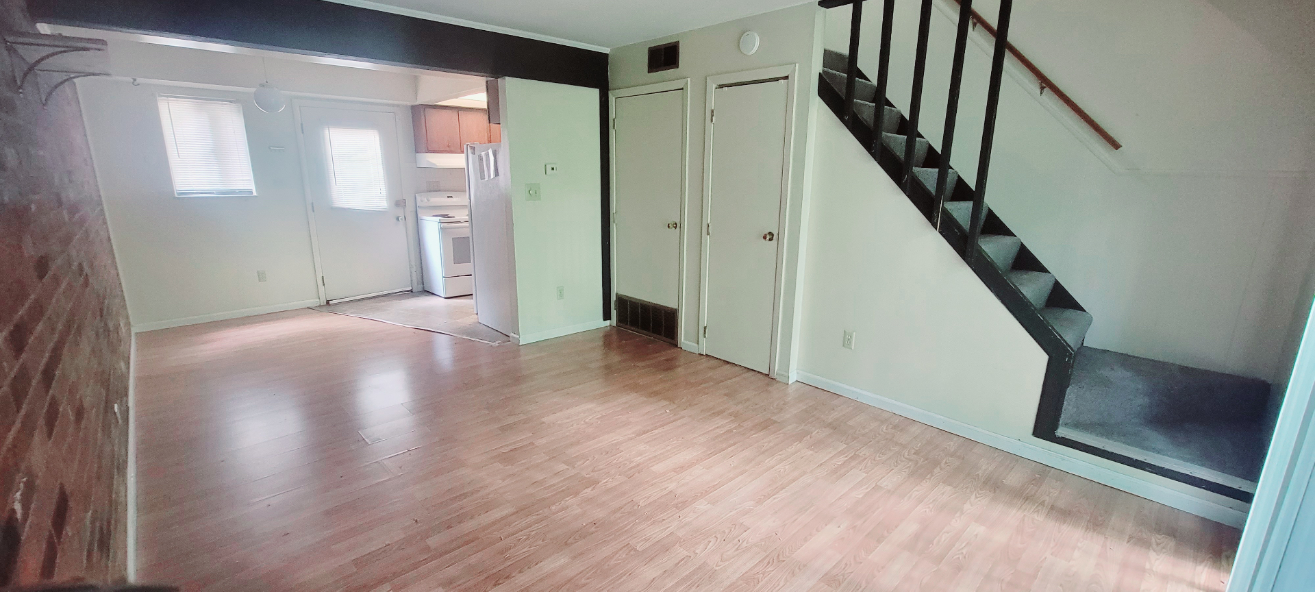 2022 Iuka Ave. bright living space with plank floors, staircase, and open sightline to the kitchen