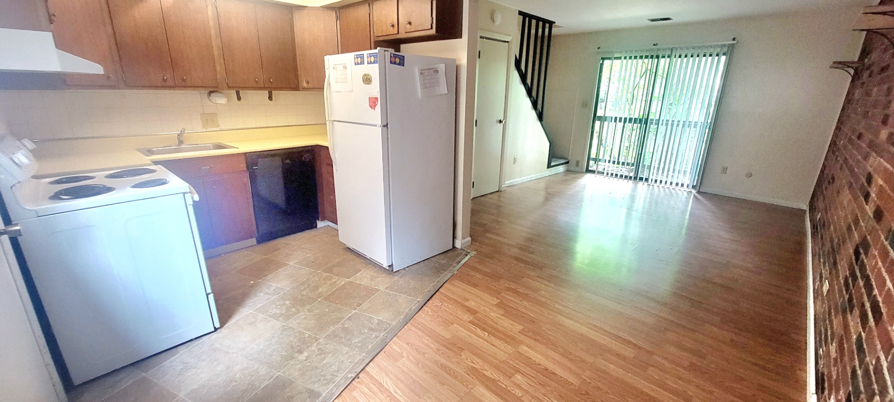 2022 Iuka Ave. kitchen with maple cabinets, white range and full-size refrigerator, and sliding doors to a private balcony
