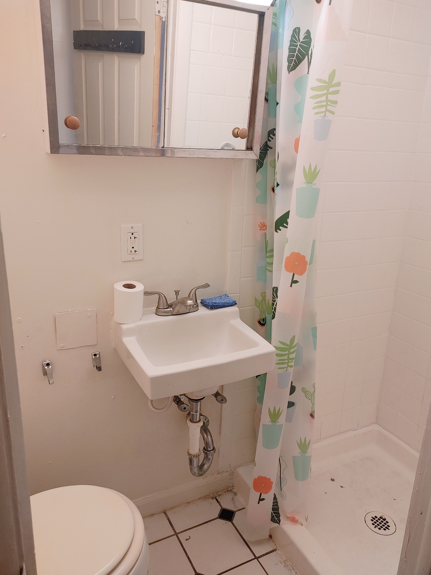 89 E Woodruff Ave. Unit C bathroom with pedestal sink, medicine cabinet, and walk-in tiled shower