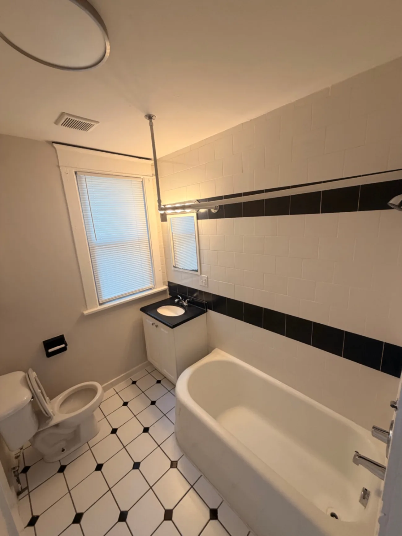 1816 Summit St. bathroom with classic black and white tile and soaking tub