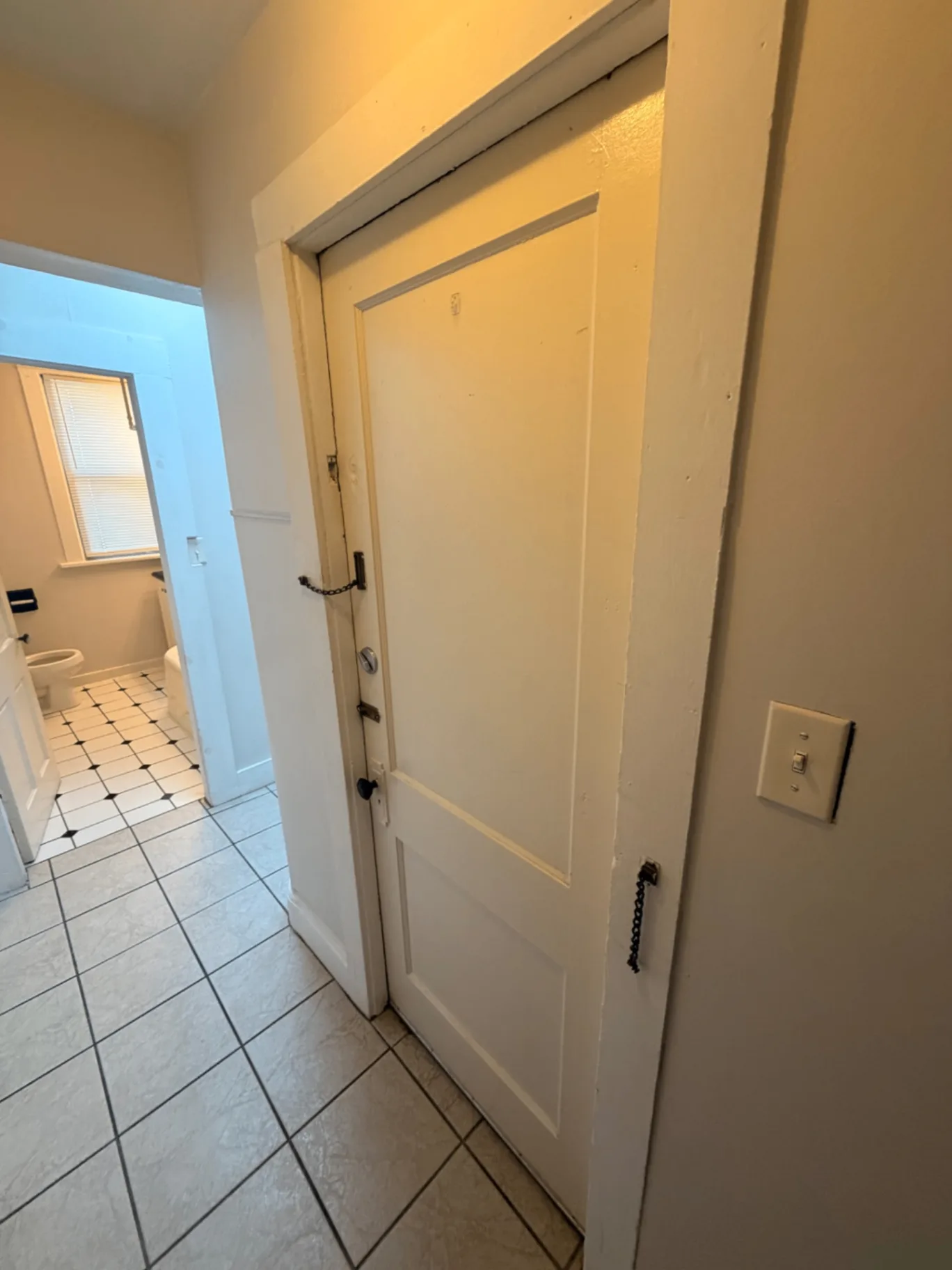 1816 Summit St. tiled entryway with secure door and bathroom access