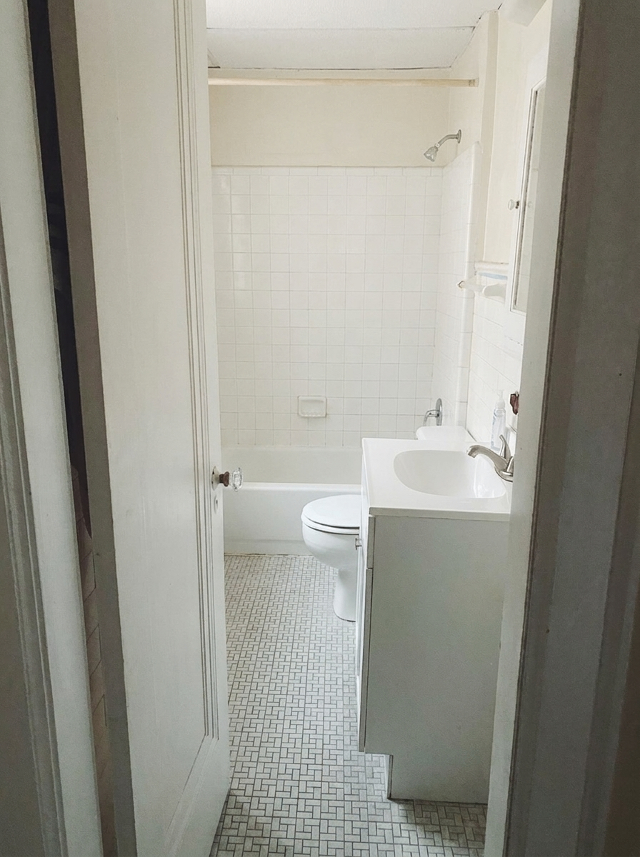 Unit H bathroom with white subway tile shower, tub, and mosaic tile floor