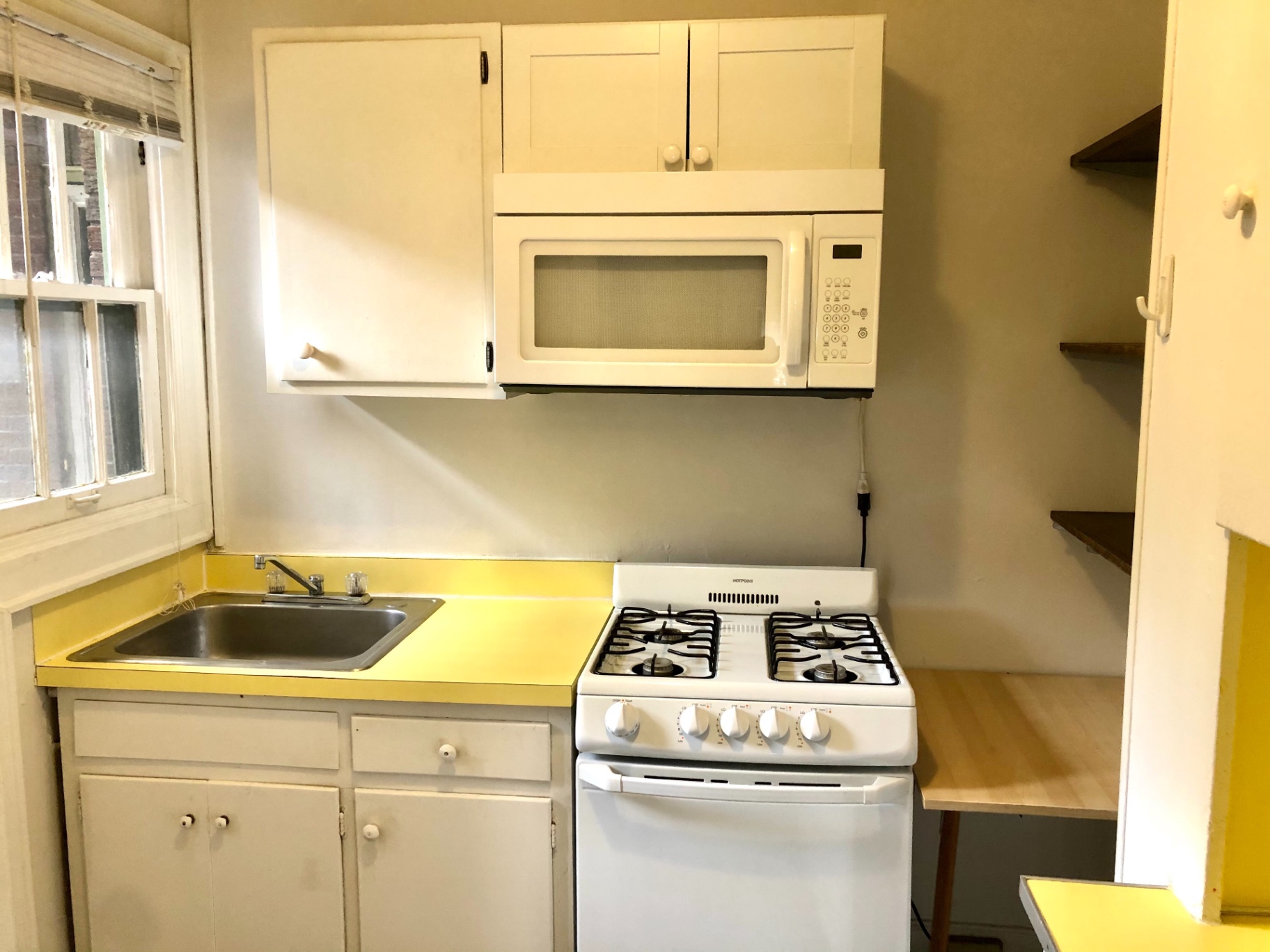 2044 Iuka Ave. B kitchen with gas range, microwave, and sunny window over the sink