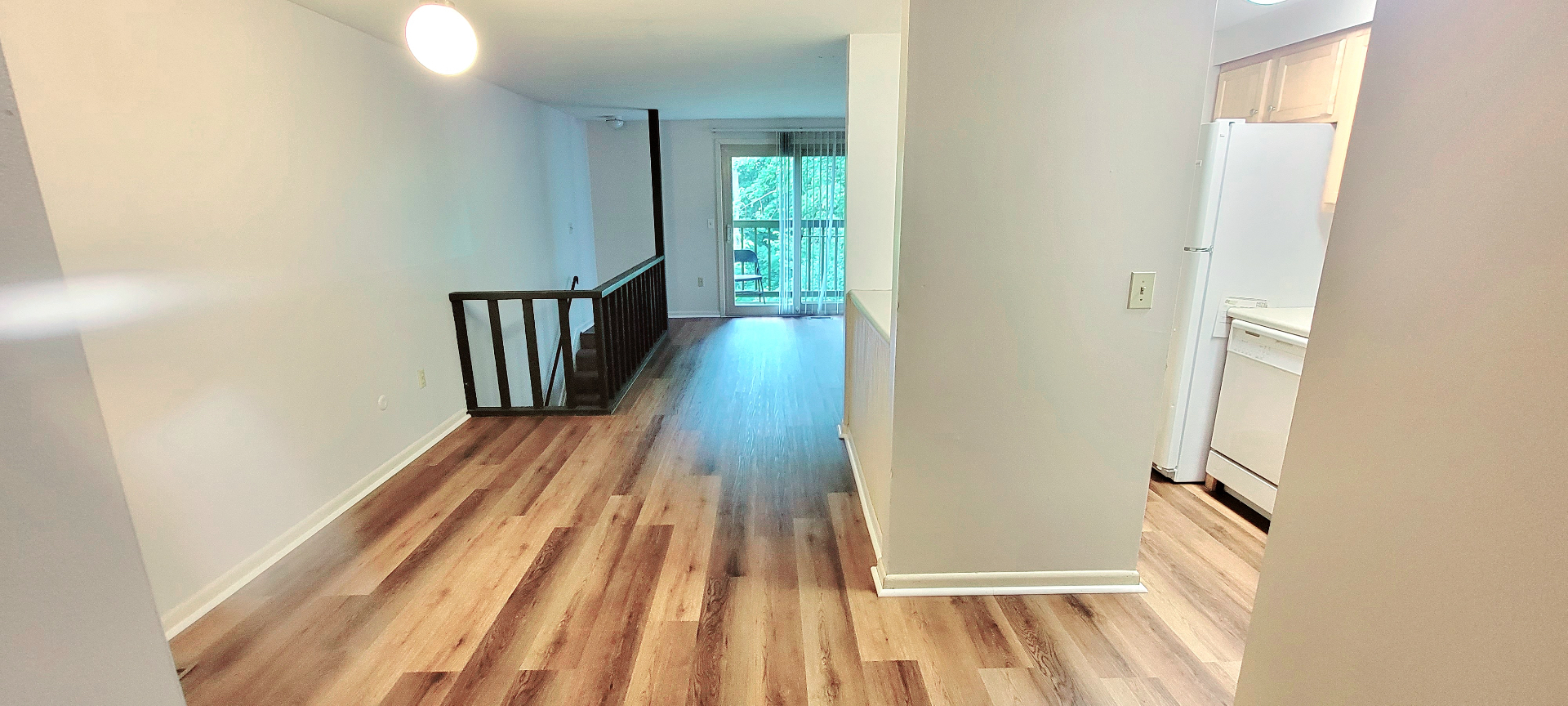 2024 Summit St. living area with sliding-door balcony access and wood-look floors