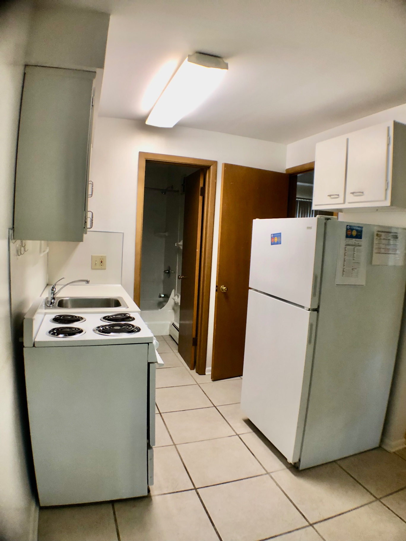 2040 Iuka Ave. 5A kitchen showing full-size refrigerator and view to bathroom