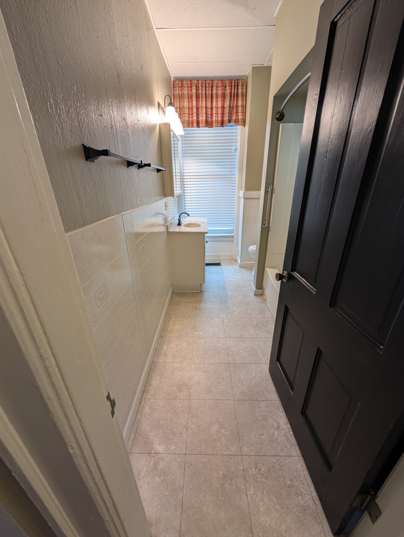 3338 Chestnut Downstairs bathroom hallway with tile floor and vanity