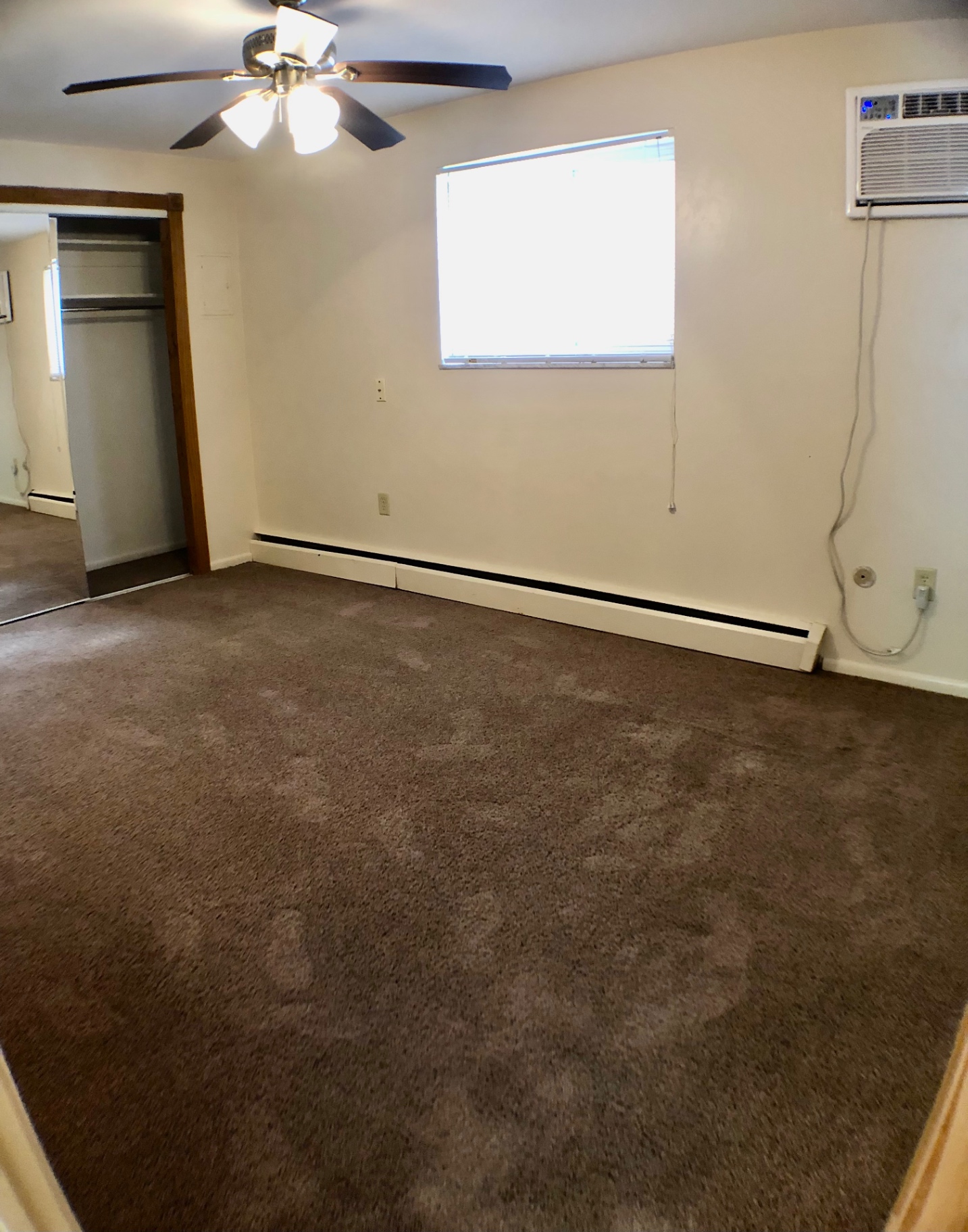 1827 N 4th St. Unit 1 bedroom with large window, ceiling fan, and window AC