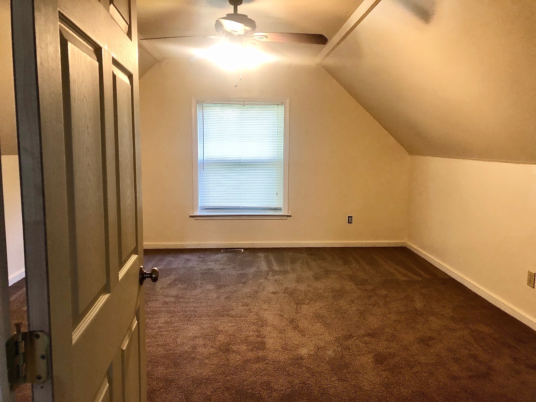 2034 Iuka Ave A vaulted upstairs bedroom with ceiling fan