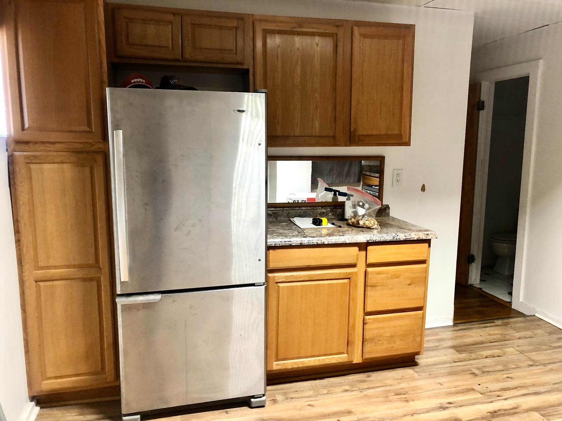 89 E Woodruff Ave. Unit 89 kitchen with full-size stainless fridge and oak cabinets