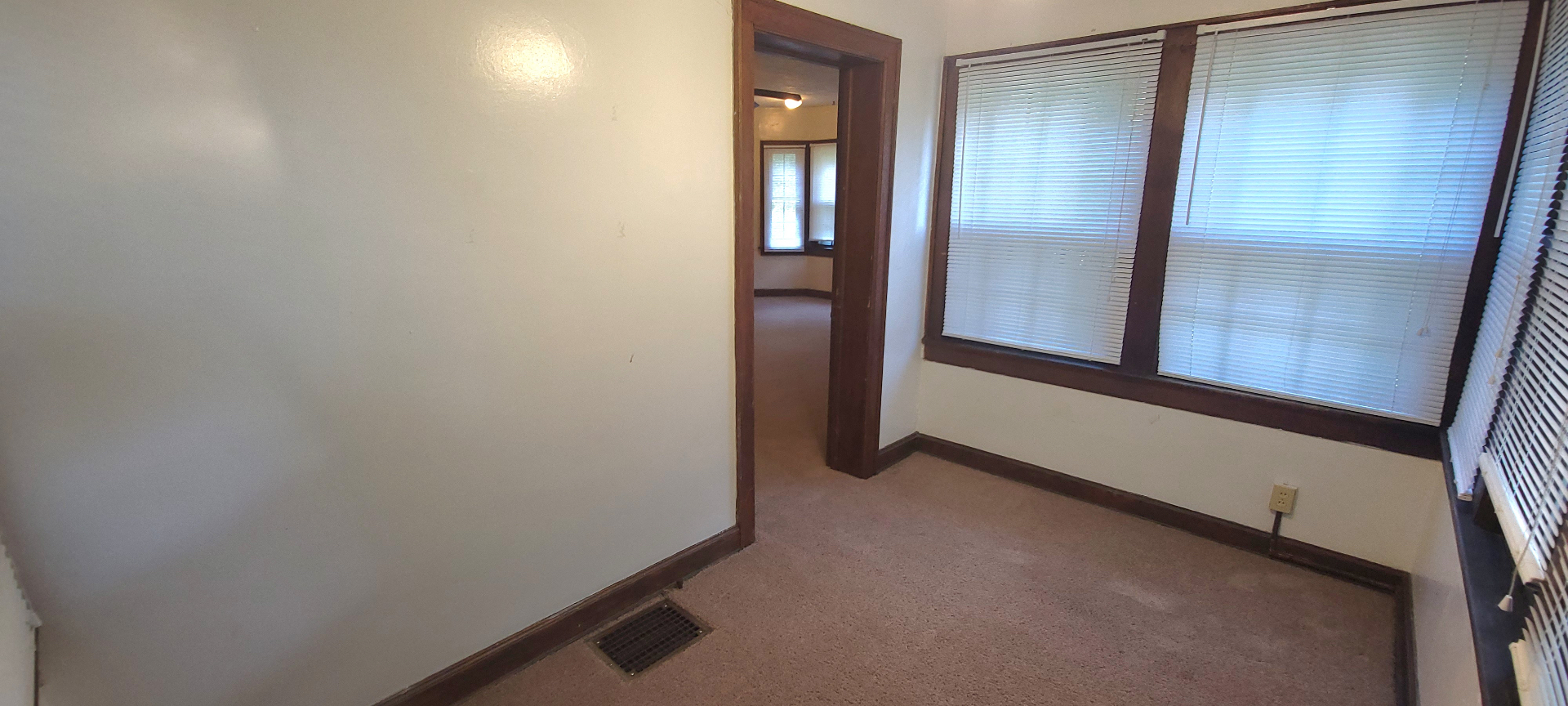 2054 Iuka Ave. C bedroom with large windows and heat vent