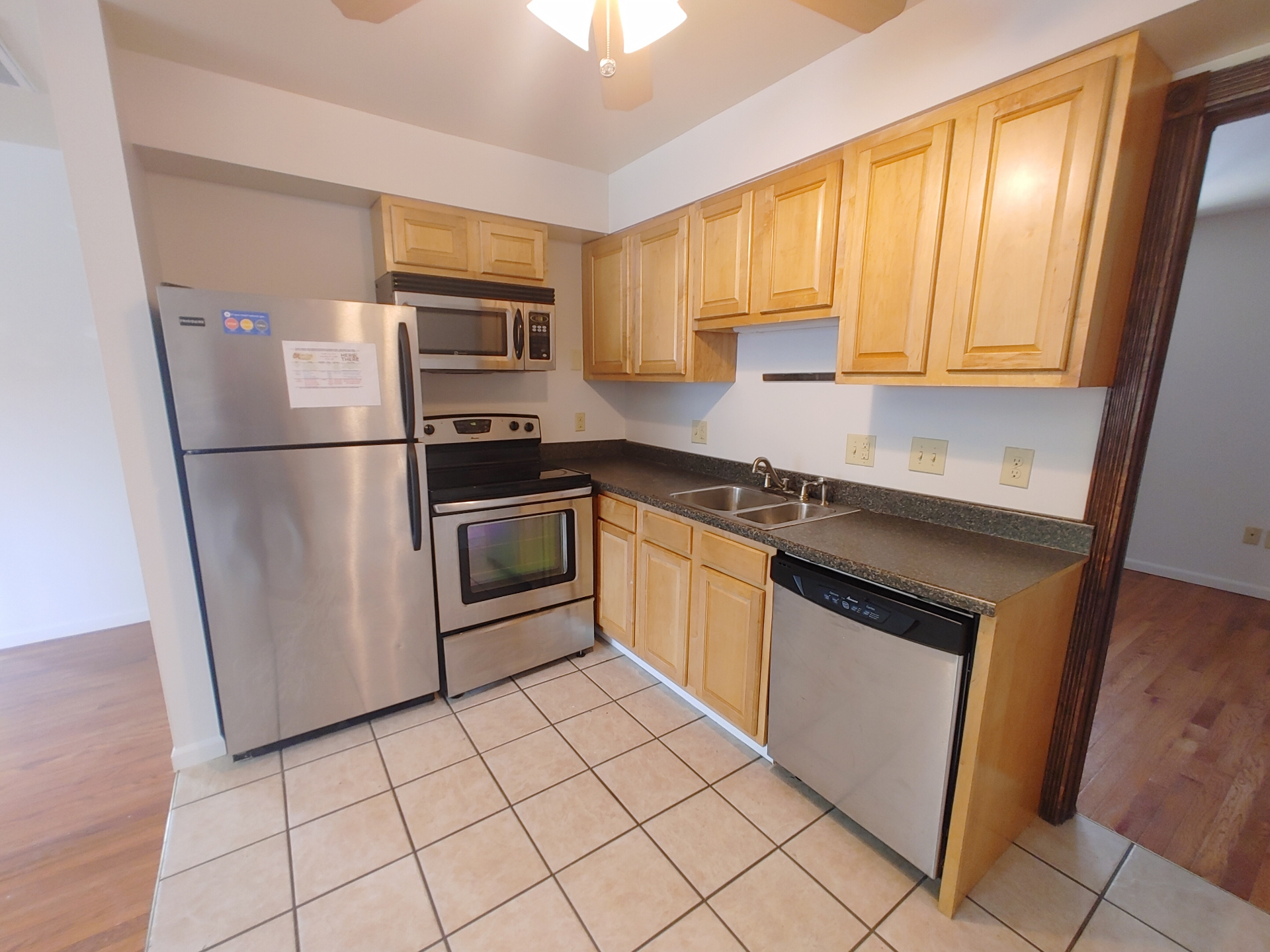 1827 N 4th St. Unit 6 kitchen with stainless fridge, microwave, electric range, dishwasher, and maple cabinetry