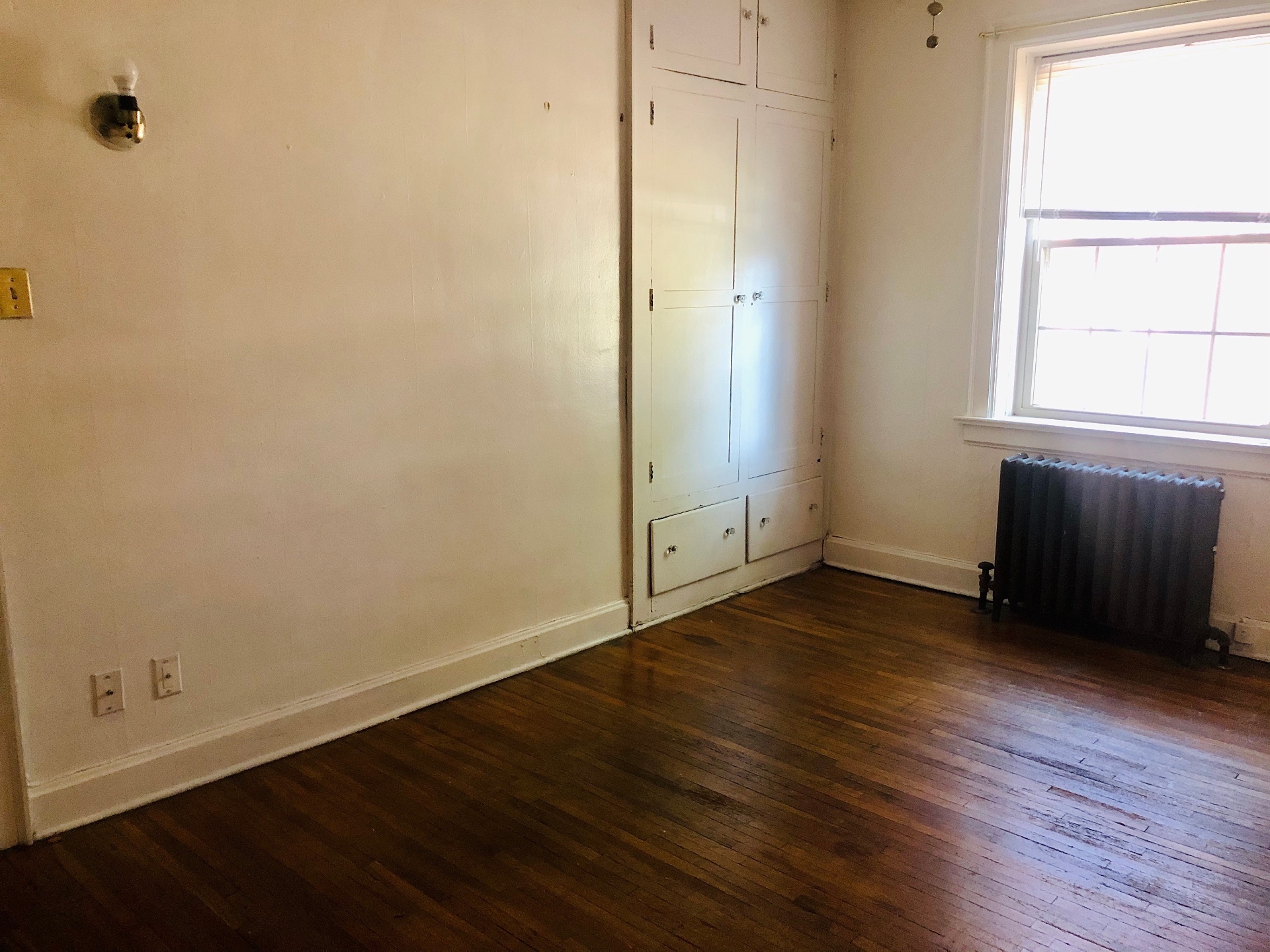 Unit G second bedroom with radiator and built-in storage