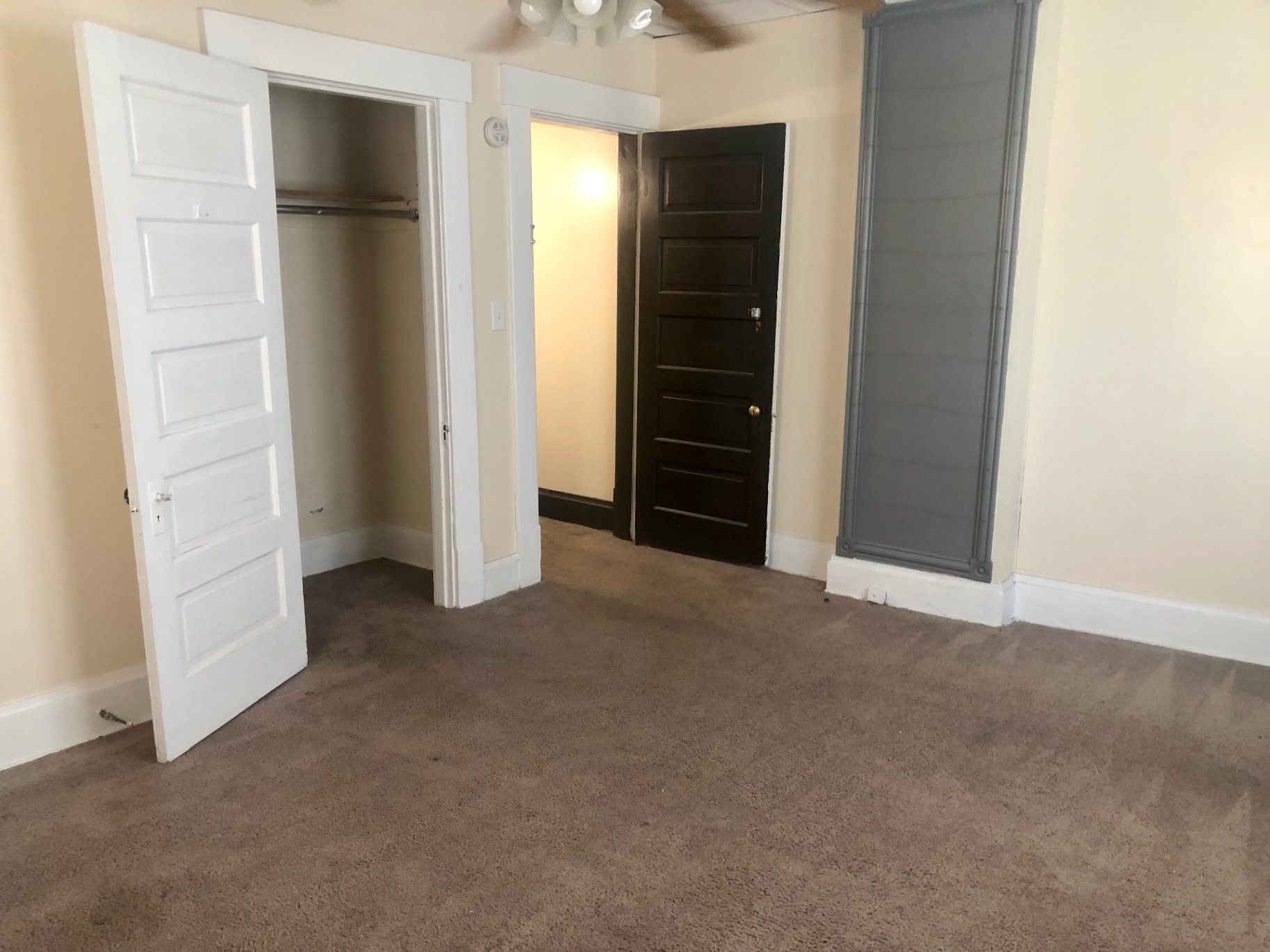 91½ E Woodruff Ave. bedroom with open closet, decorative trim, and carpeted floors