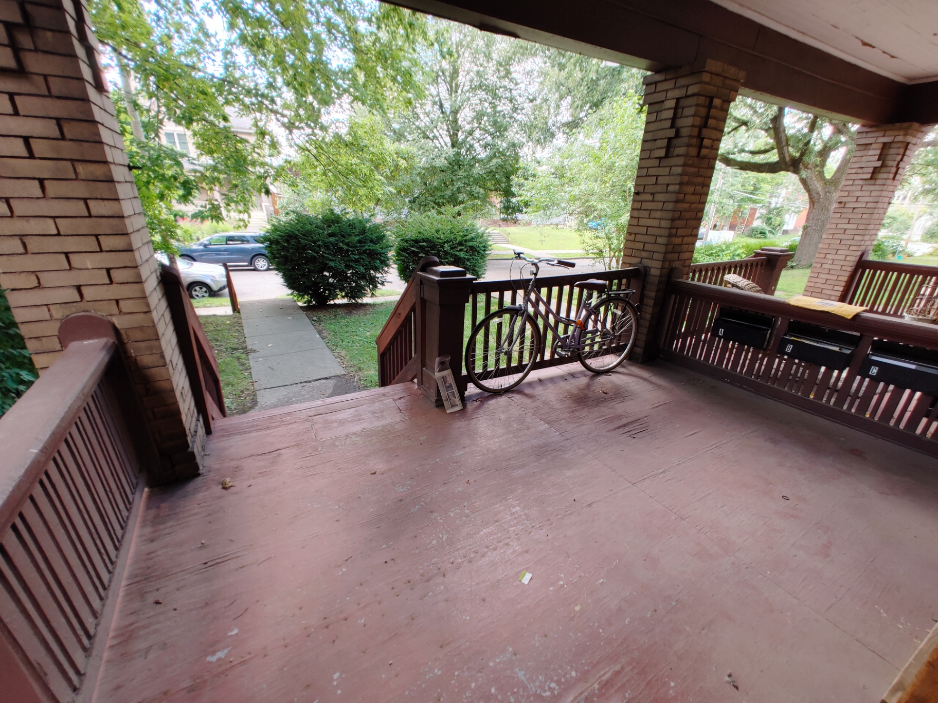 374 A E 14th Ave. wide view of the shared front porch with tree-lined street beyond