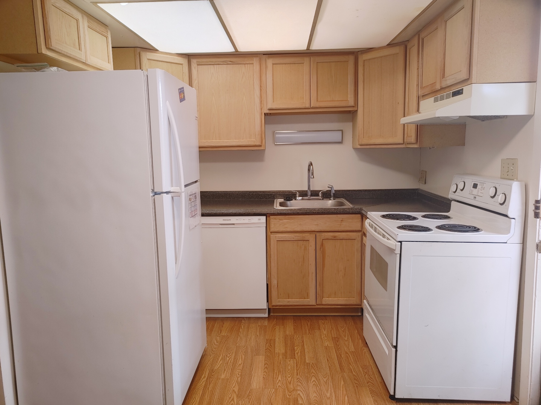 2020 Iuka Ave. kitchen with maple cabinets, white range, dishwasher, and full-size refrigerator