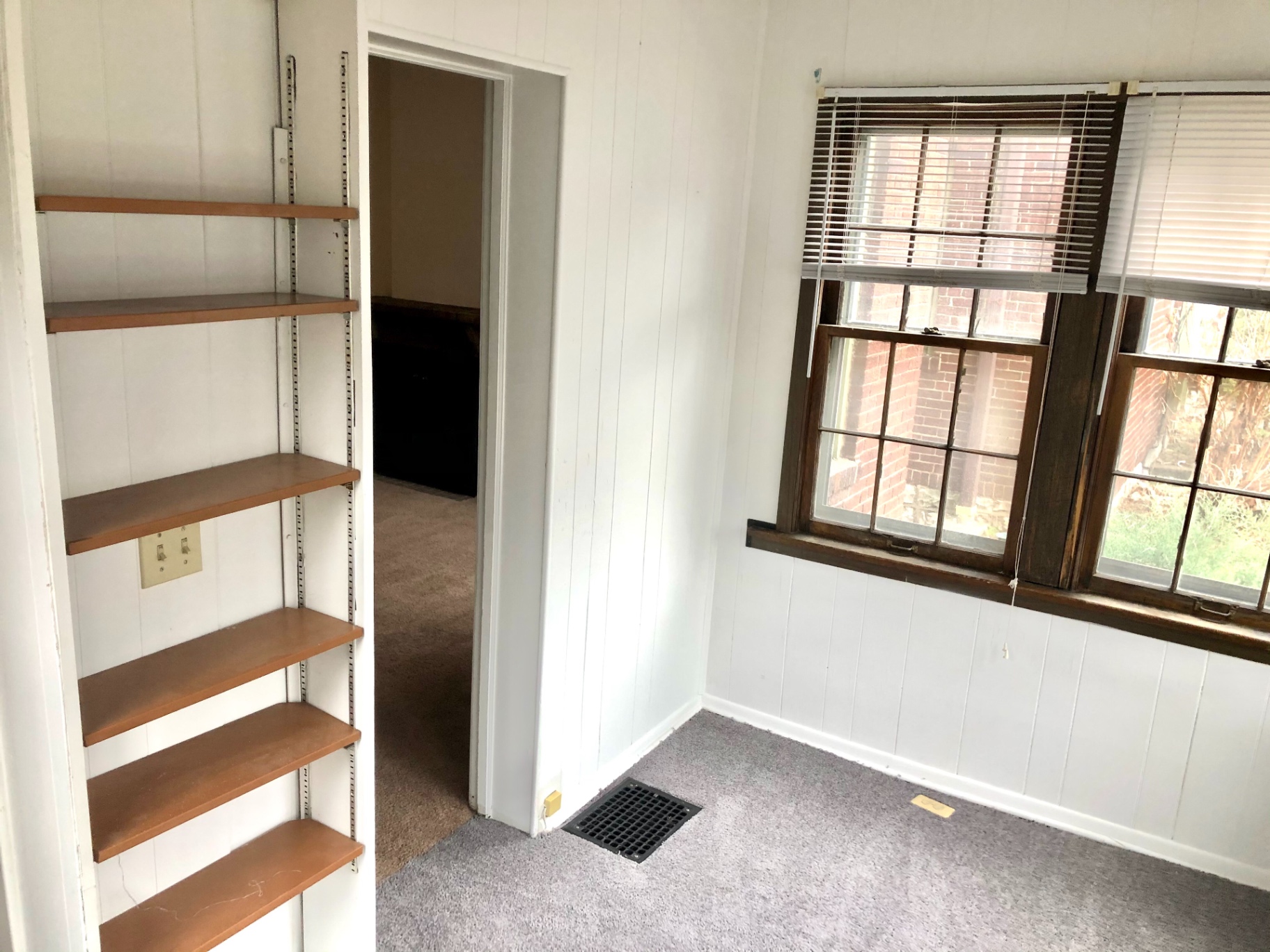 2044 Iuka Ave. B room with built-in shelving and bright double windows
