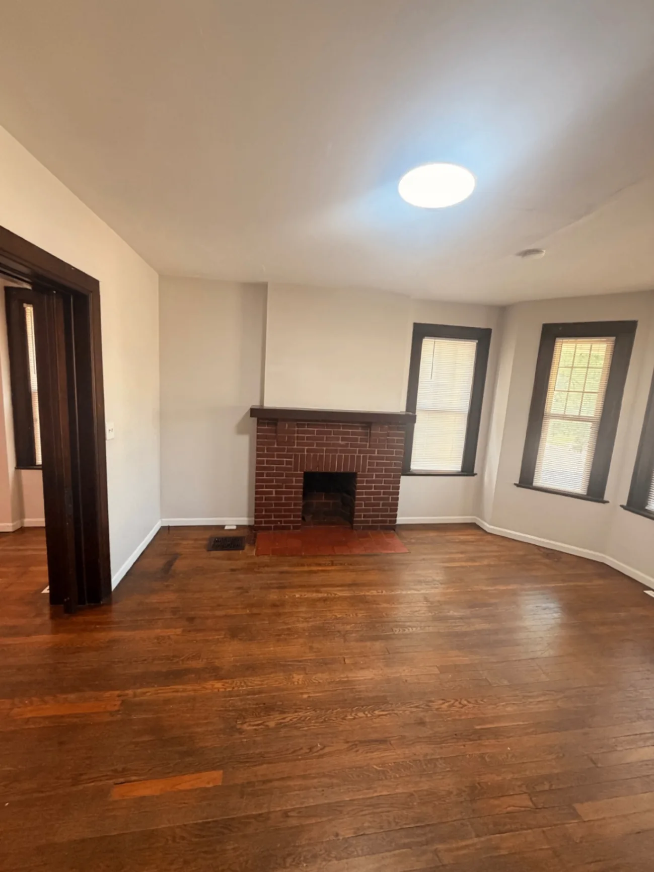 1816 Summit St. living area with brick fireplace and bright windows