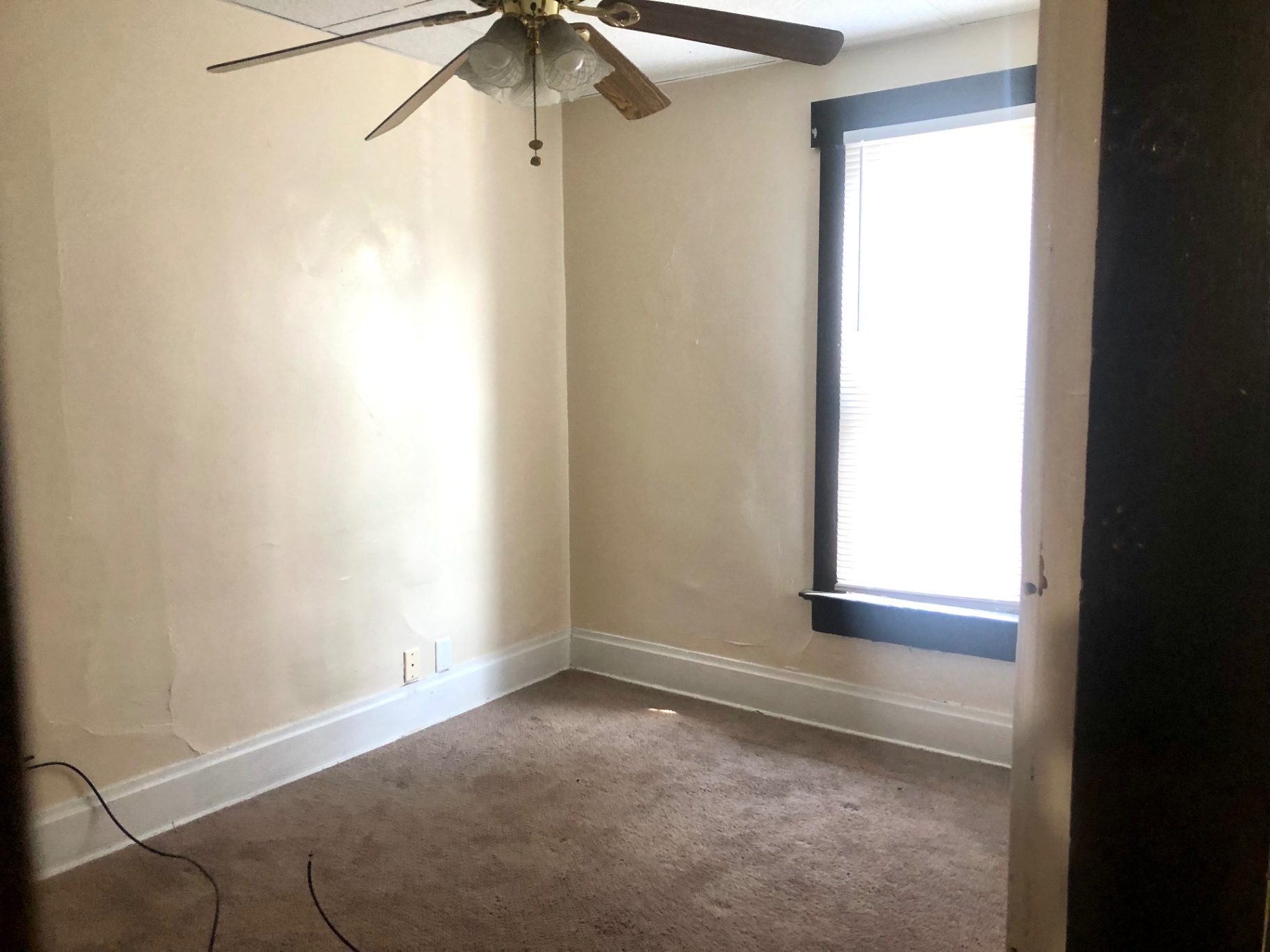 91½ E Woodruff Ave. additional carpeted bedroom with ceiling fan and corner window
