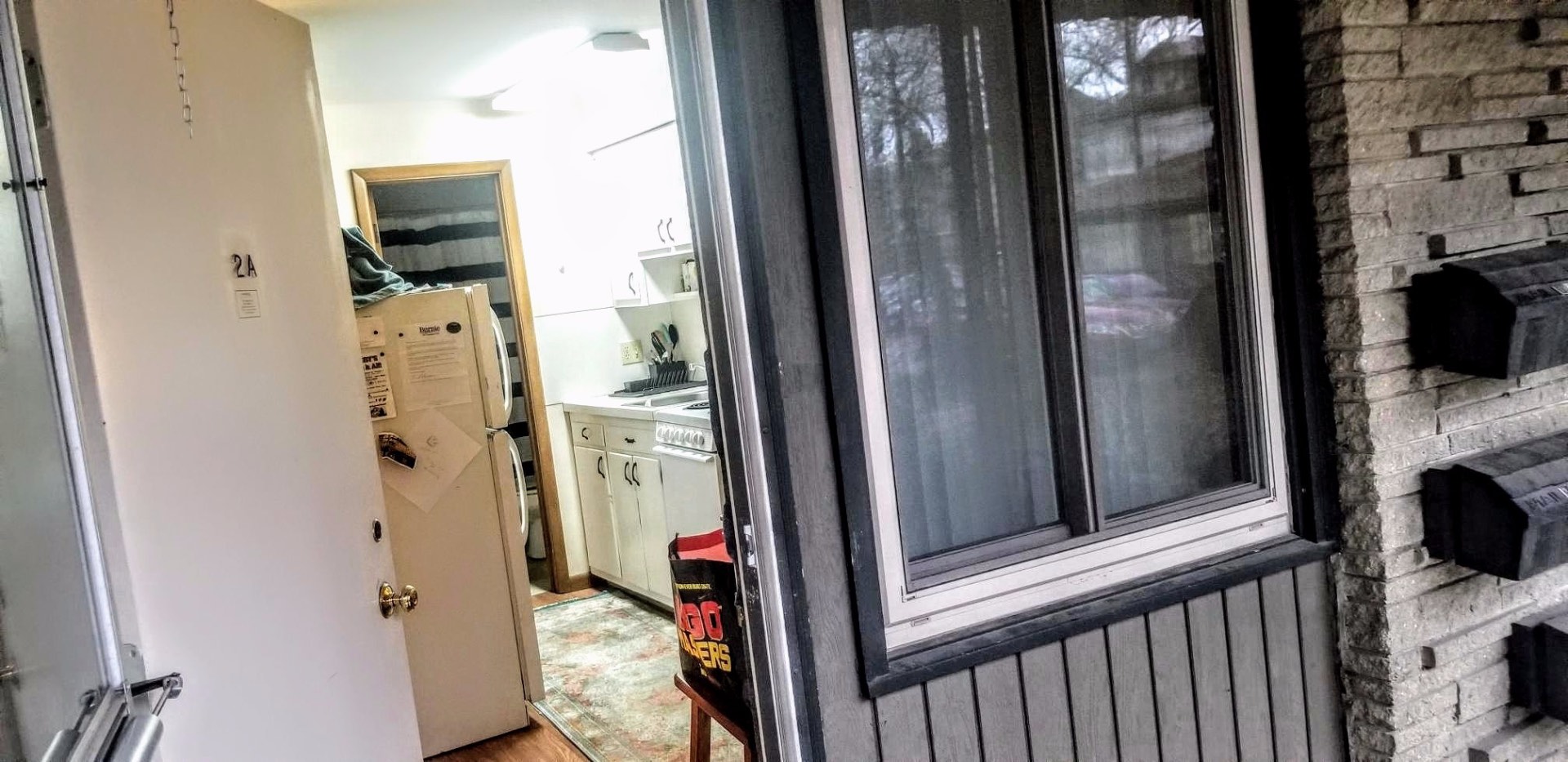2040 Iuka Ave. 2A private entry door with view into kitchen and stacked washer/dryer