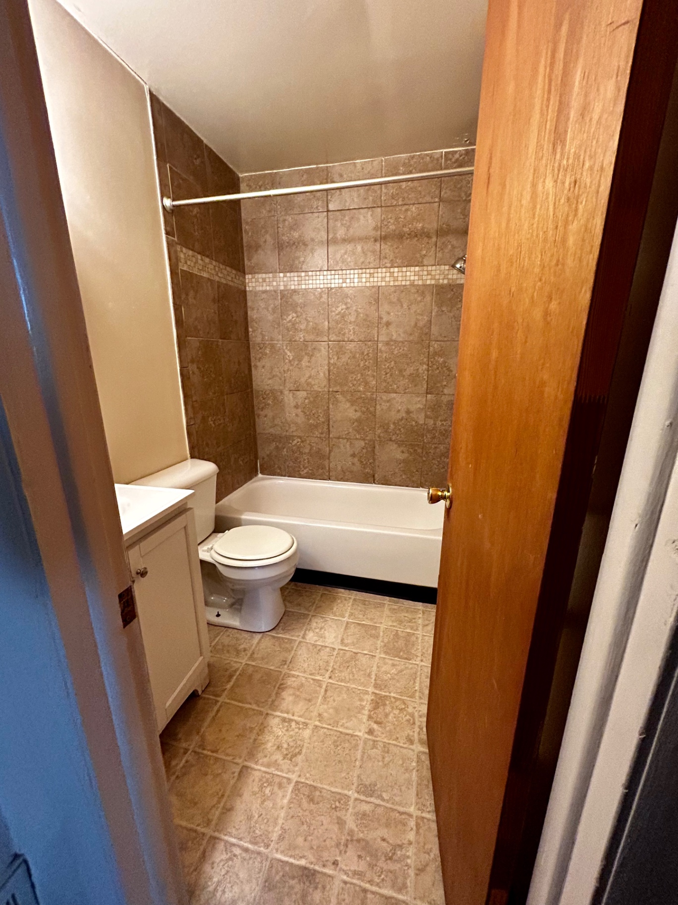 2150 N 4th St. Unit B bathroom with tiled tub surround and white vanity