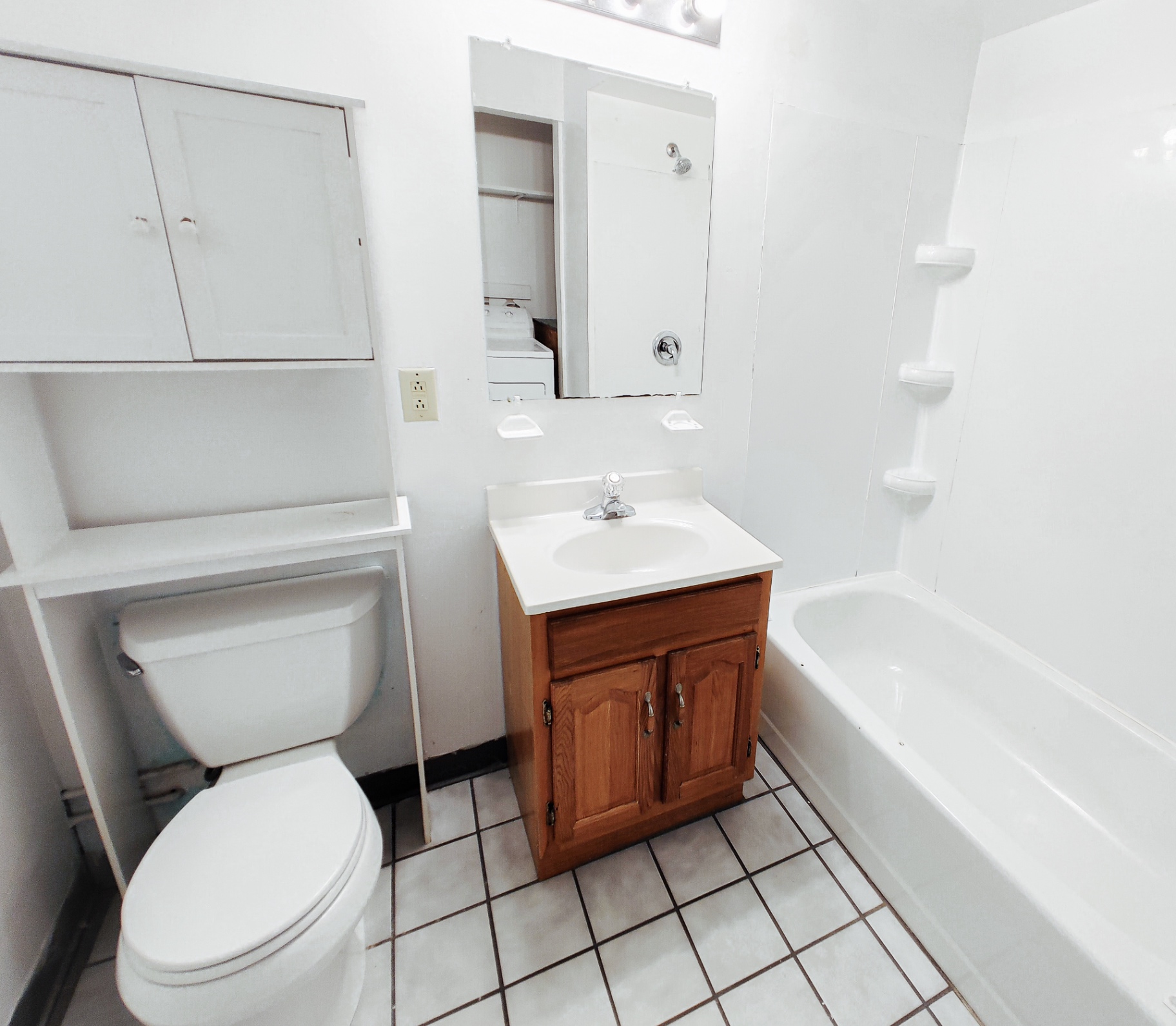 Rear unit bathroom with tub/shower, vanity and storage cabinets
