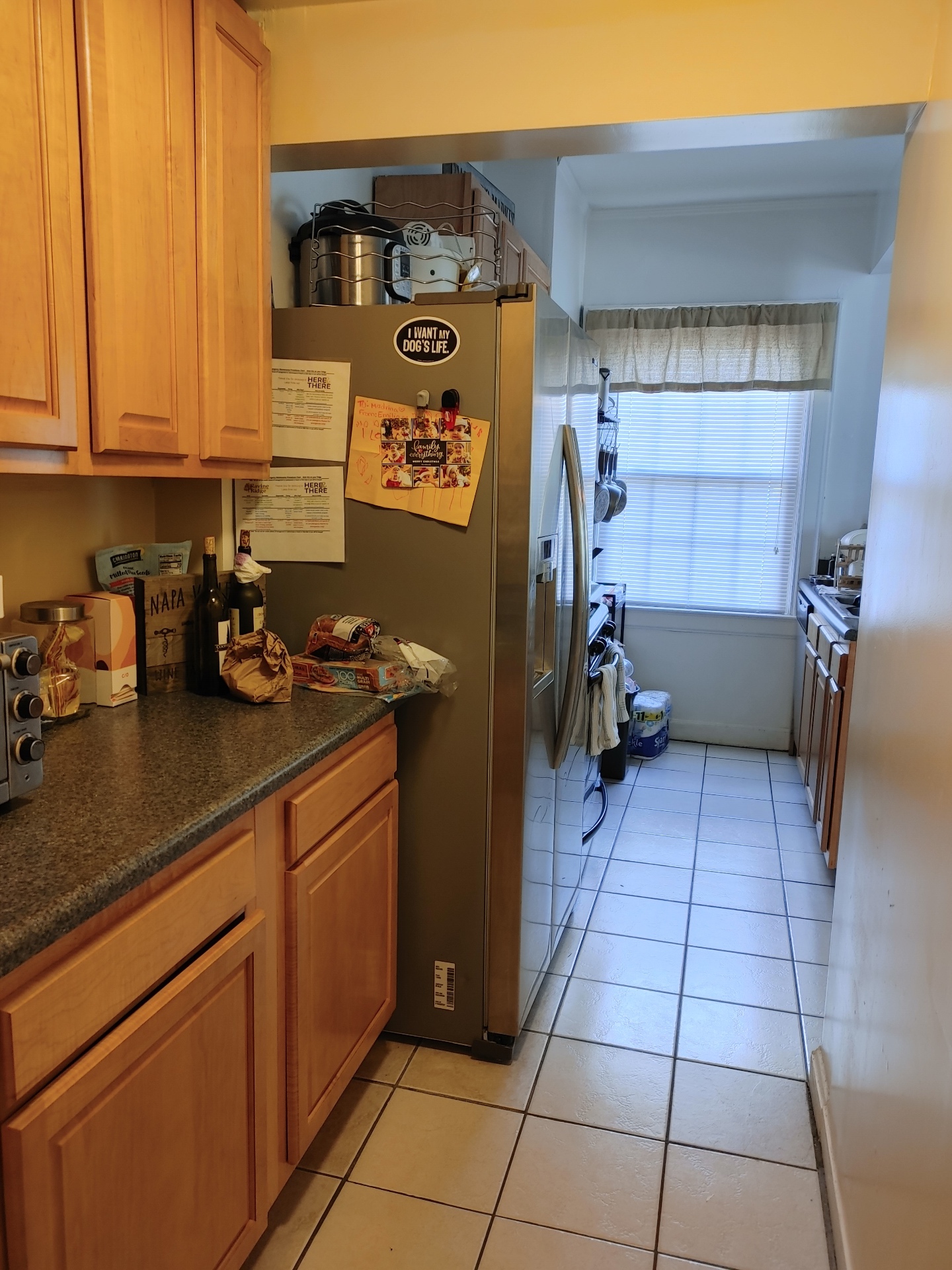 Unit G kitchen with wood cabinets and tile floor