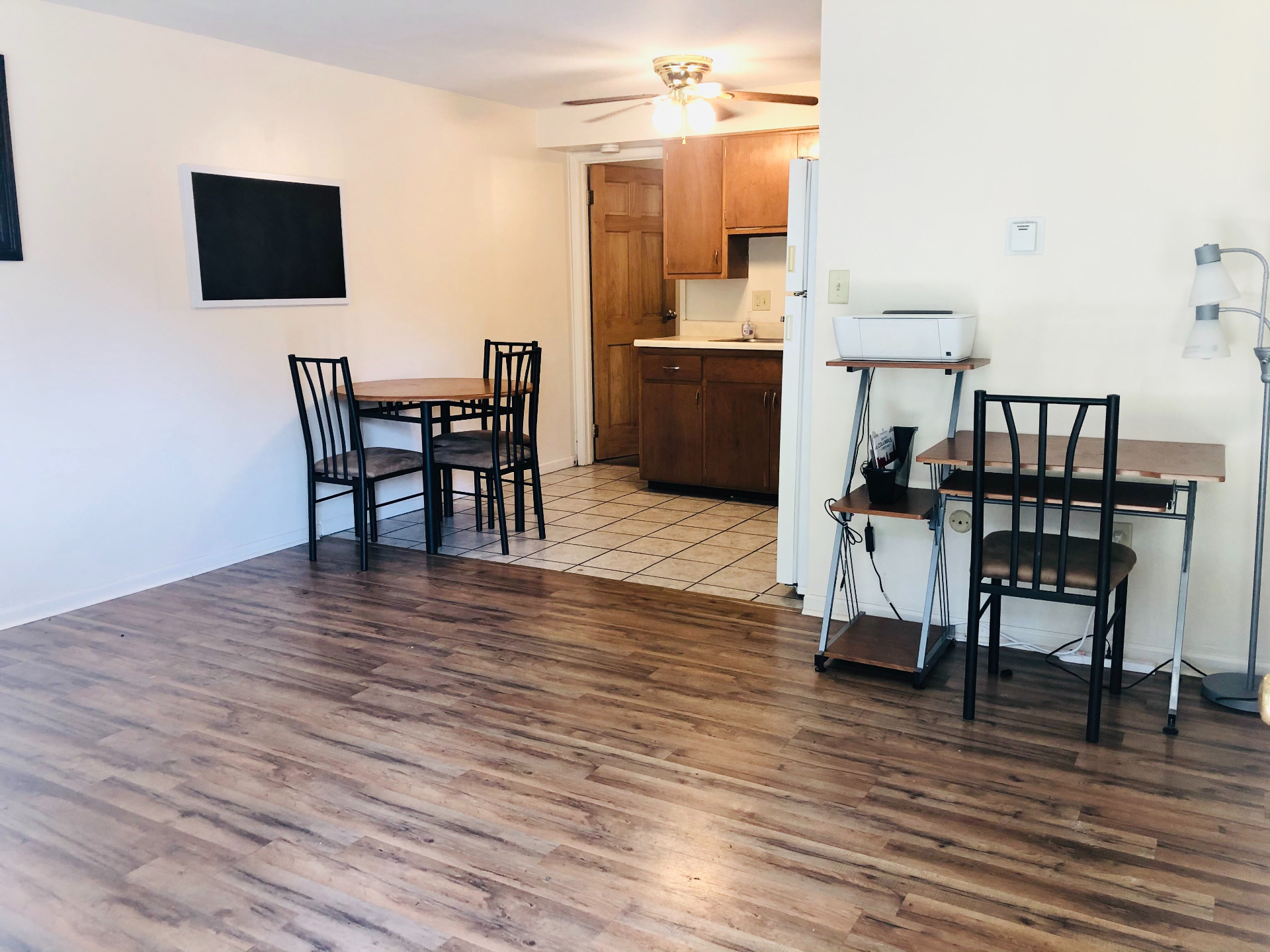 1827 N 4th St. Unit 2 living area with wood-look flooring, ceiling fan, and open tile kitchen