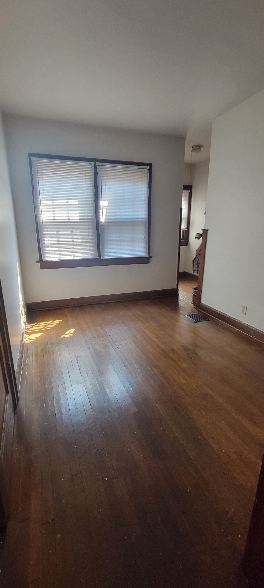 2044 Iuka Ave. C bright bedroom with hardwood floors, wide double windows, and original wood trim