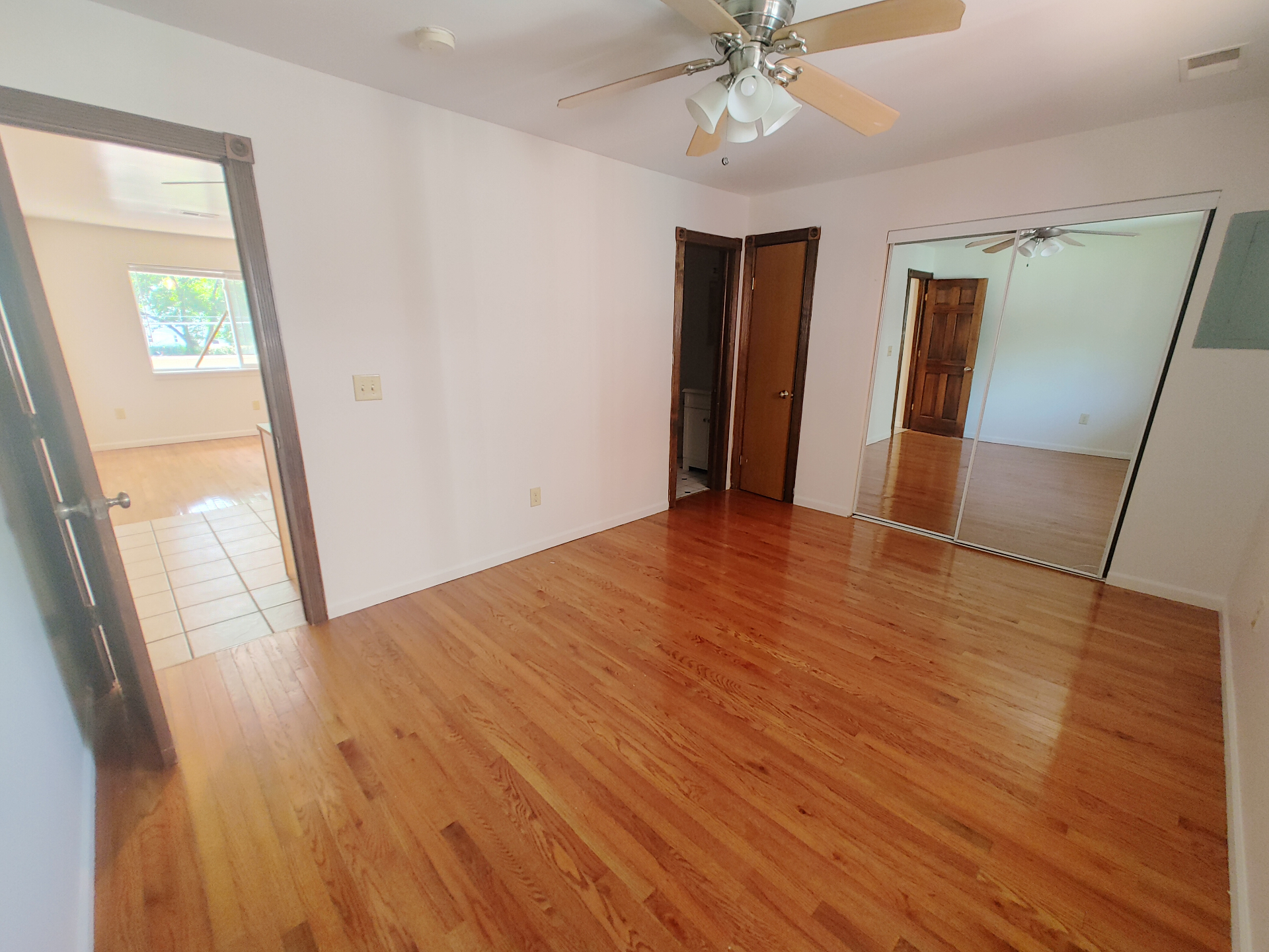 1827 N 4th St. Unit 6 spacious bedroom with hardwood floors, mirrored closet, and nearby bath access