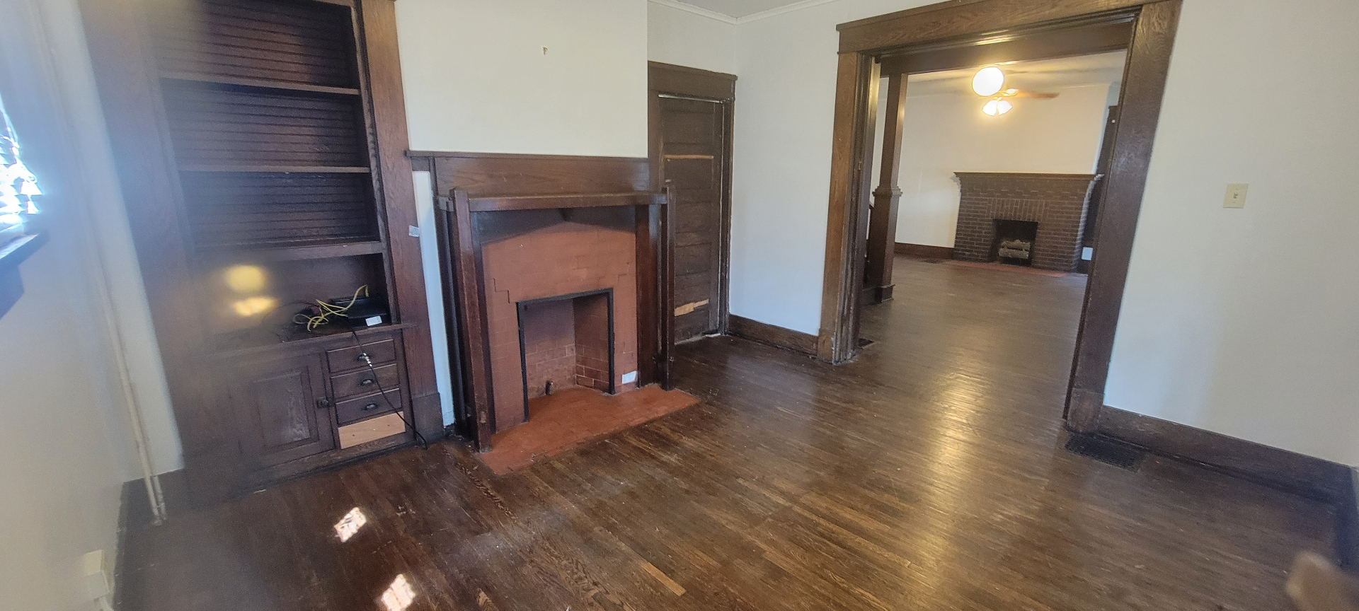 2015 Summit St. front parlor with brick fireplace opening into the main living room