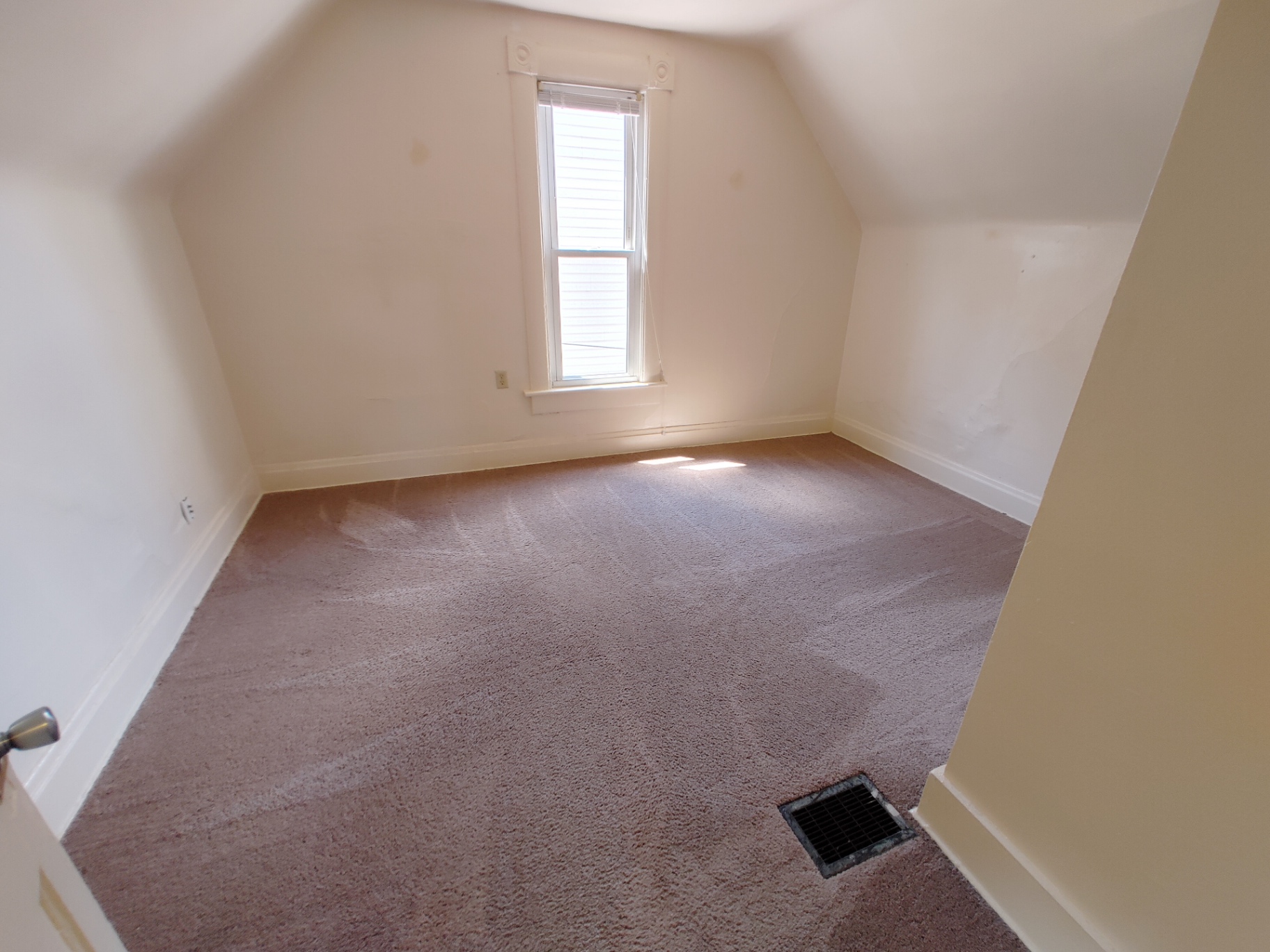 Rear unit upstairs bedroom with vaulted ceiling and fresh carpet