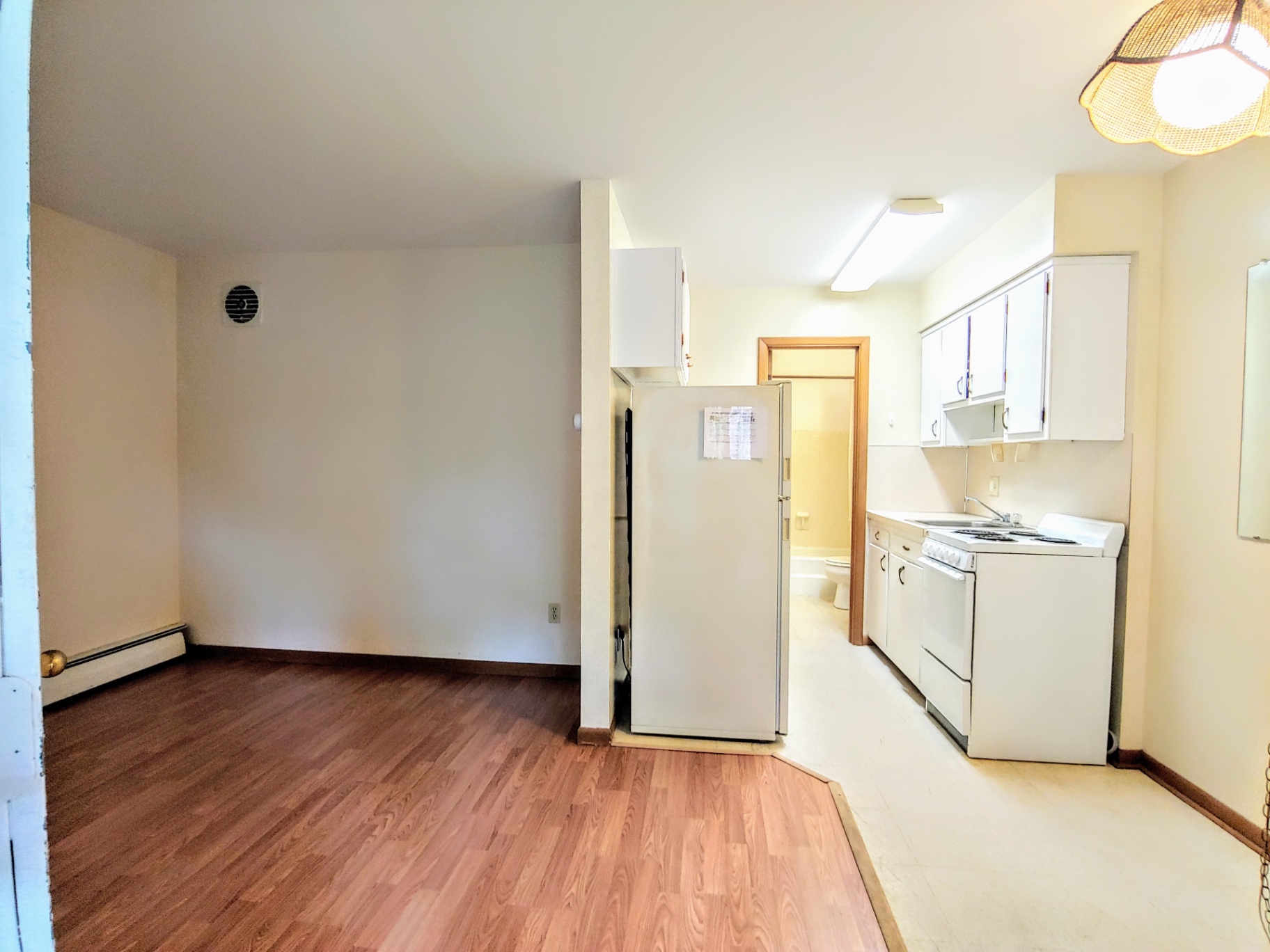 2040 Iuka Ave 4B open living area with wood-look floors and kitchen