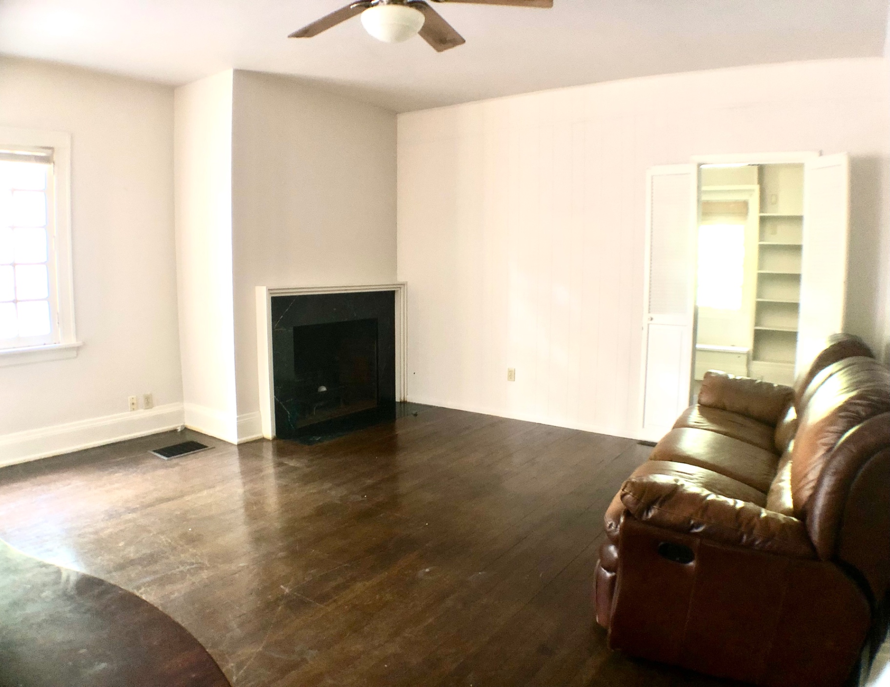 2026 Iuka Ave A living room with leather seating, fireplace, and built-in shelving