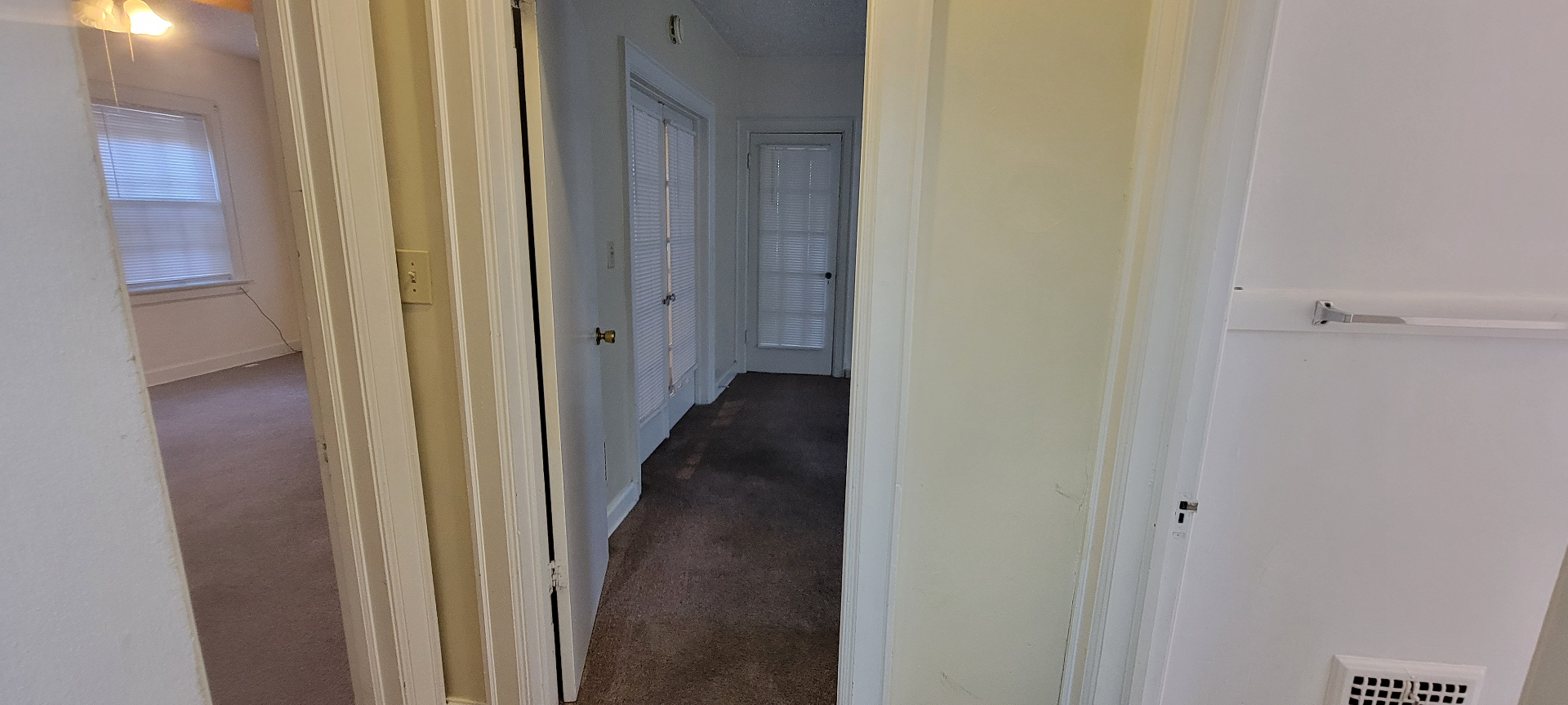 2044 Iuka Ave. D interior hallway with original wood doors leading to the bedrooms and bath