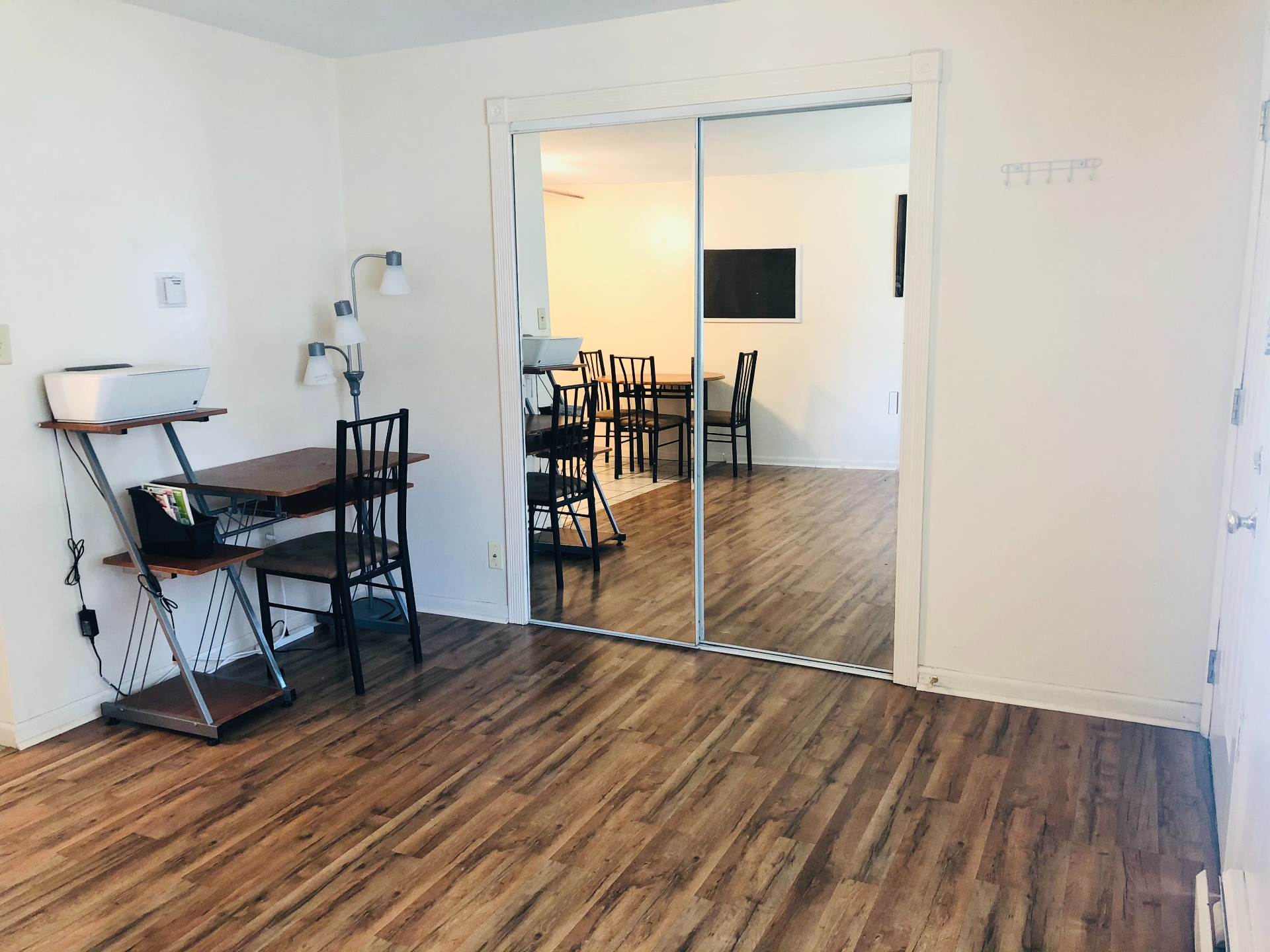 1827 N 4th St. Unit 2 living area with mirrored closet doors and wood-look flooring