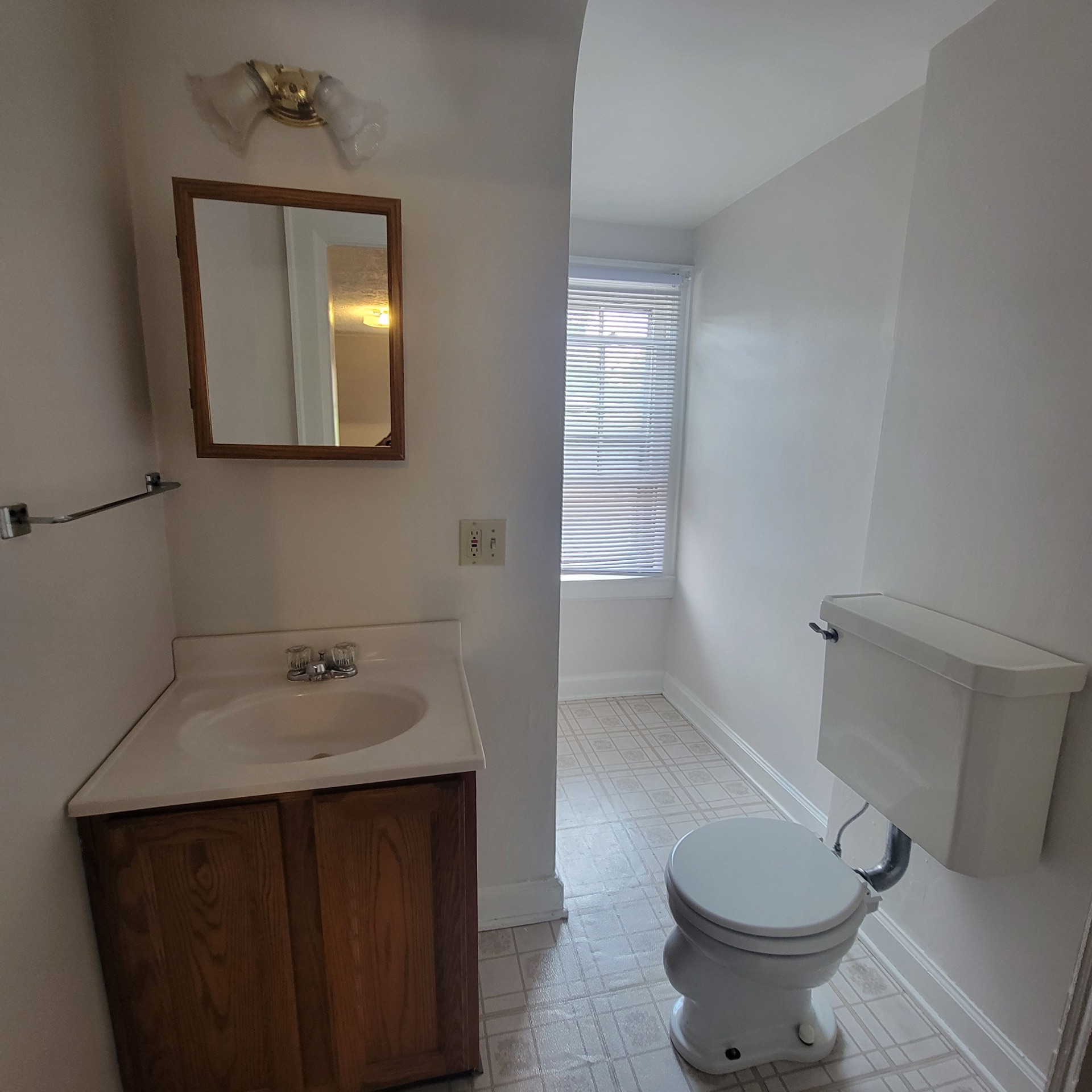 2048 Iuka Ave. C half bath with vanity, medicine cabinet, and window